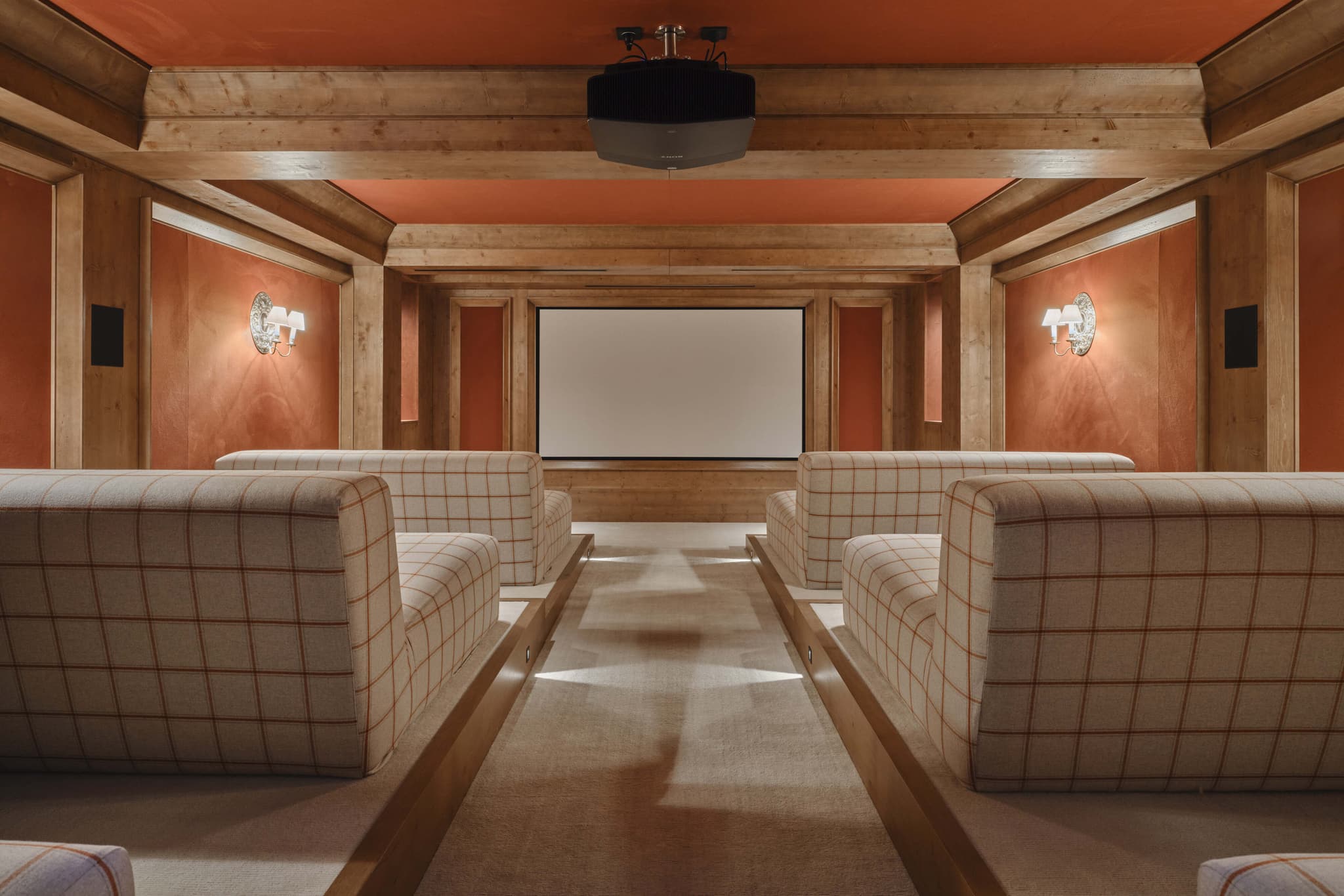 Private cinema with ceiling-mounted projector and tiered lounge seating