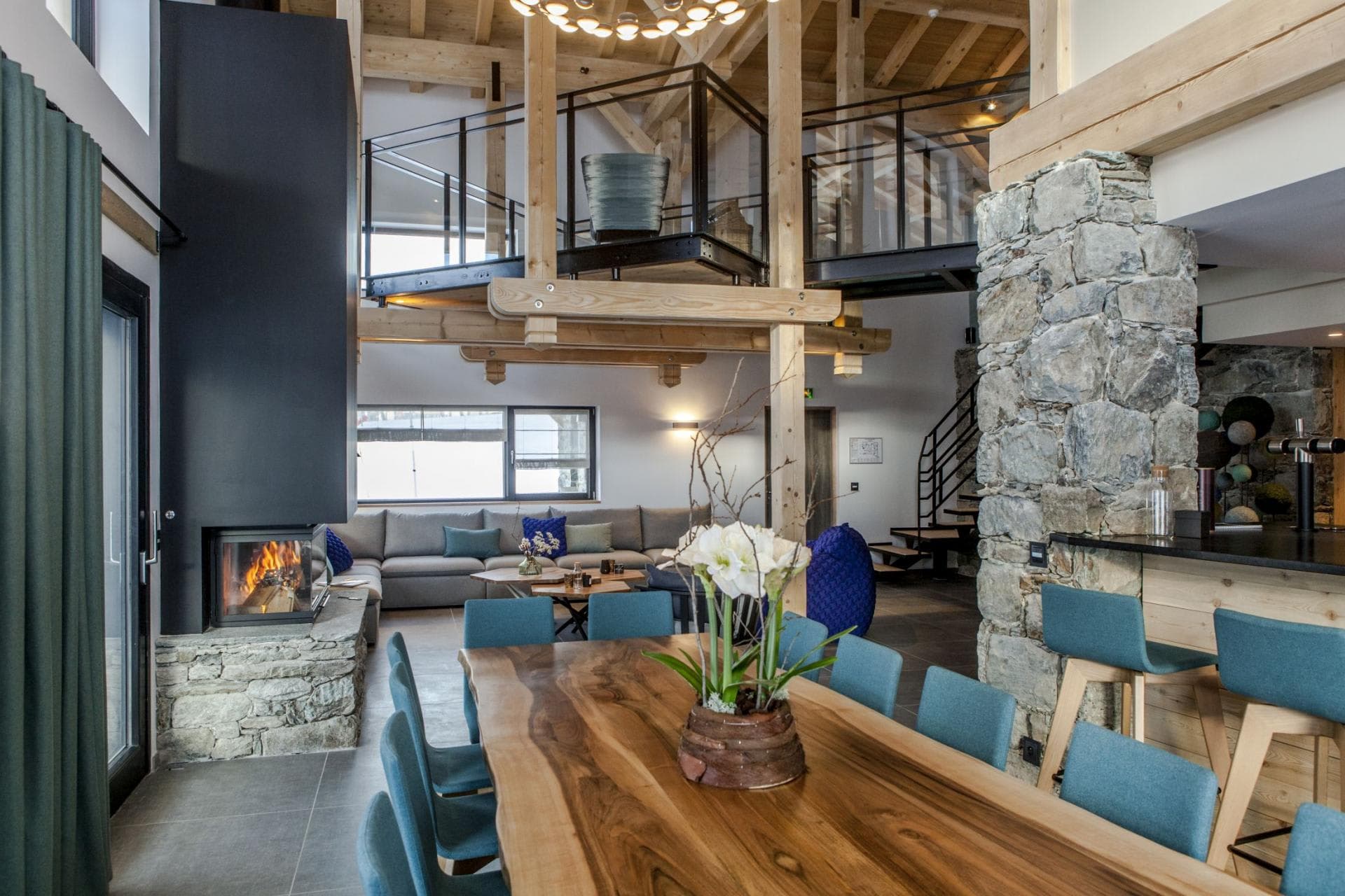 Open-plan dining area and lounge with fireplace and mezzanine level