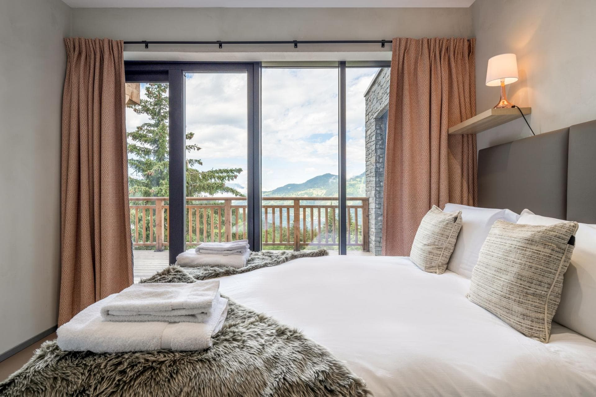 Bedroom with terrace access and floor-to-ceiling mountain views