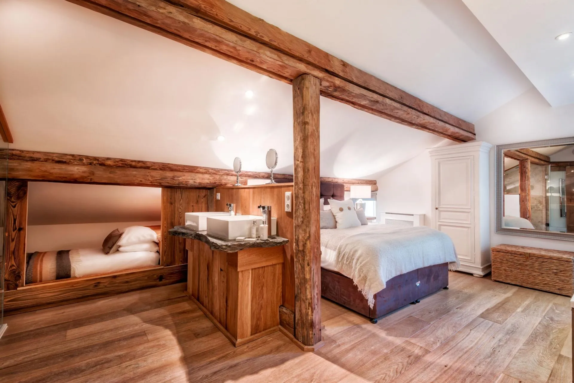 Loft bedroom with queen bed, dual vanity, and built-in children's bunk