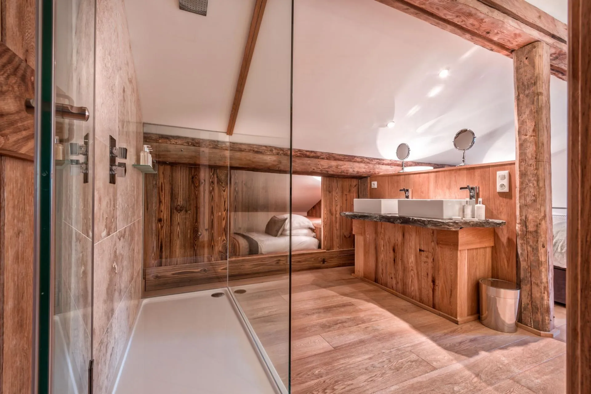 Ensuite bathroom with dual vessel sinks and glass-walled walk-in shower