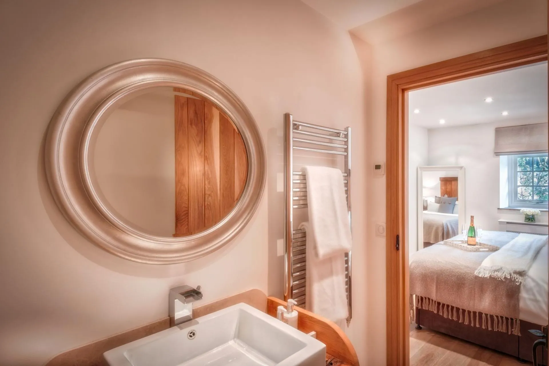 Ensuite bathroom with heated towel rail and views into bedroom
