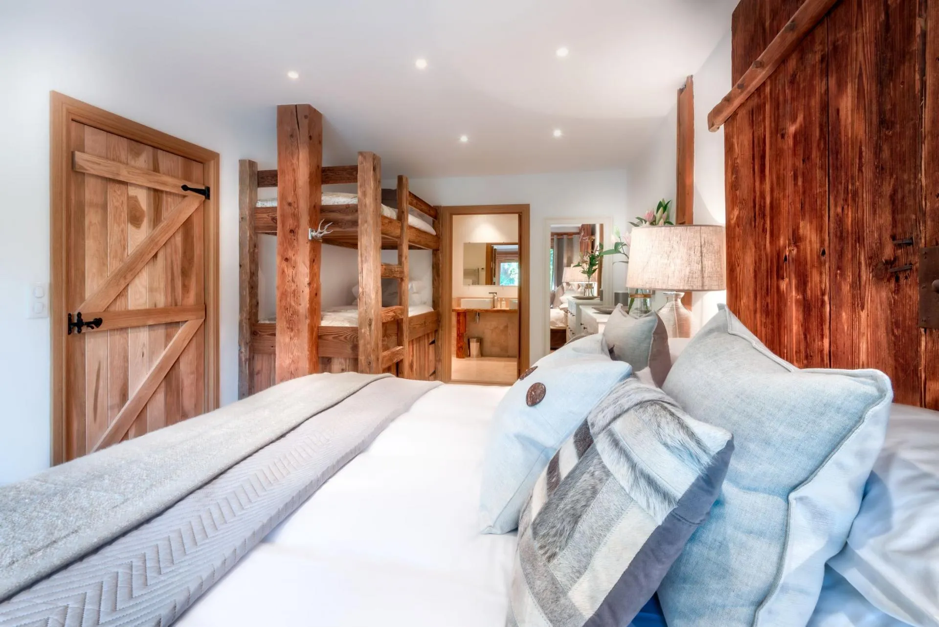Family bedroom with king bed, built-in twin bunks, and ensuite bathroom