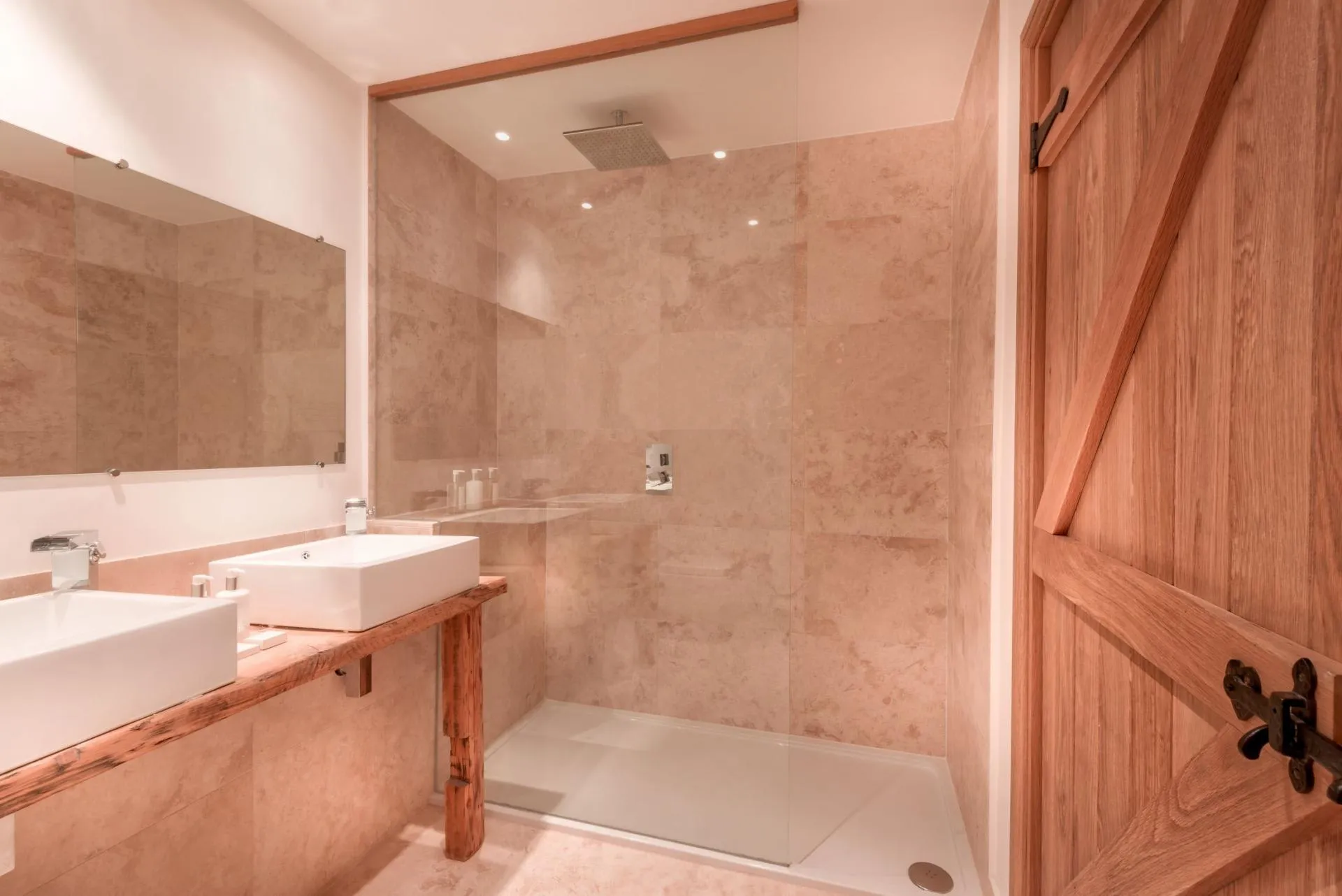 Bathroom with dual vessel sinks and walk-in rainfall shower