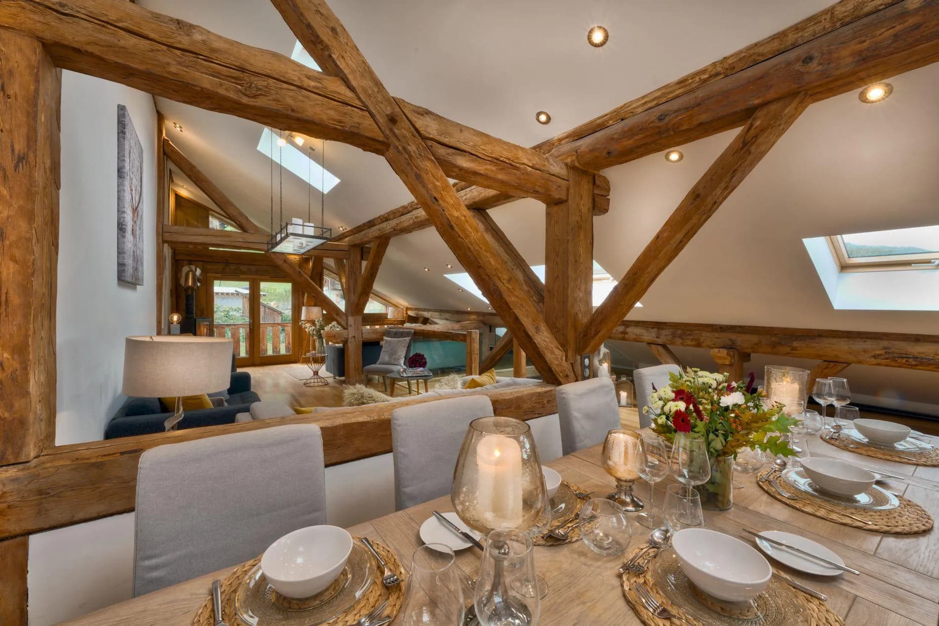 Open-plan dining area with original timber beams and skylights