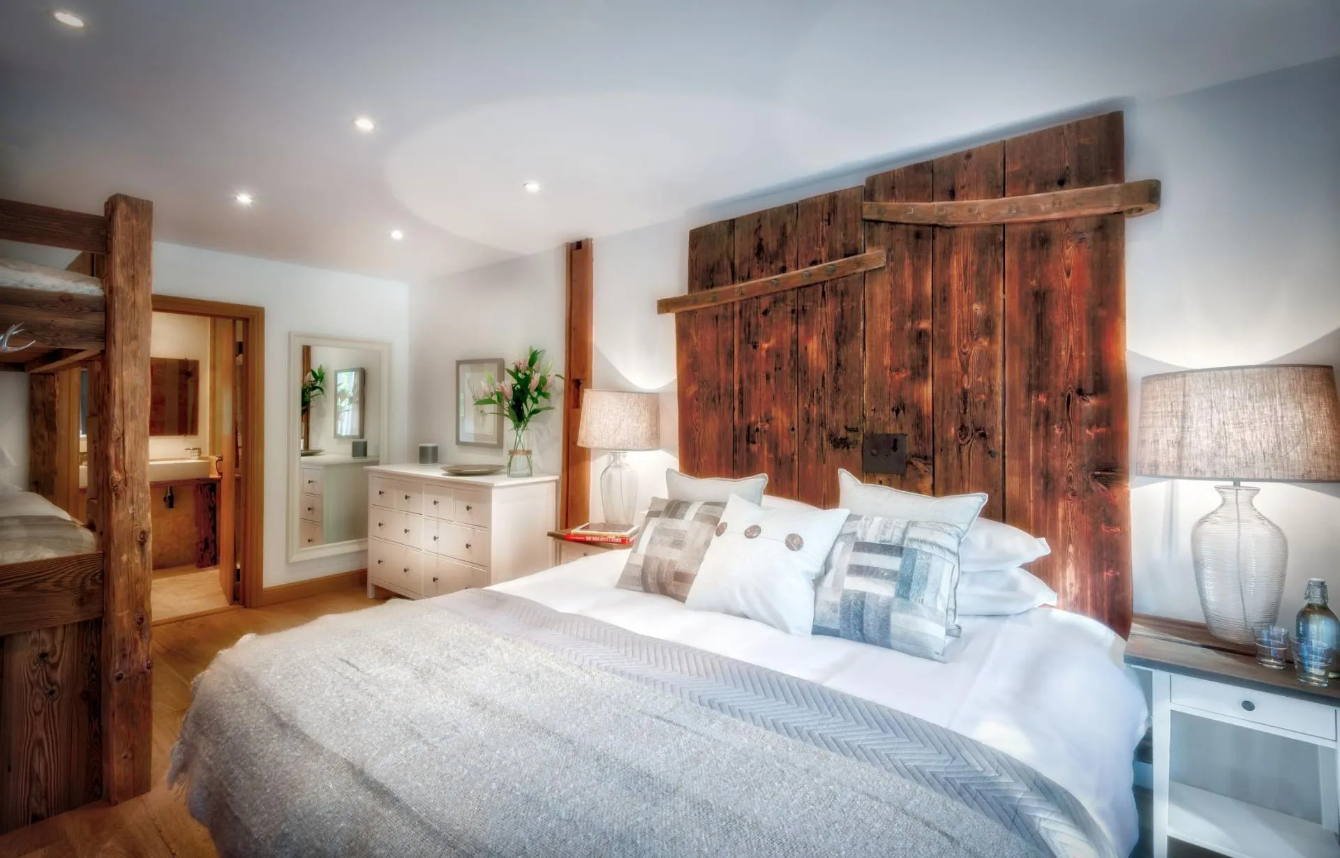 Guest bedroom with king bed, built-in bunks, and ensuite bathroom
