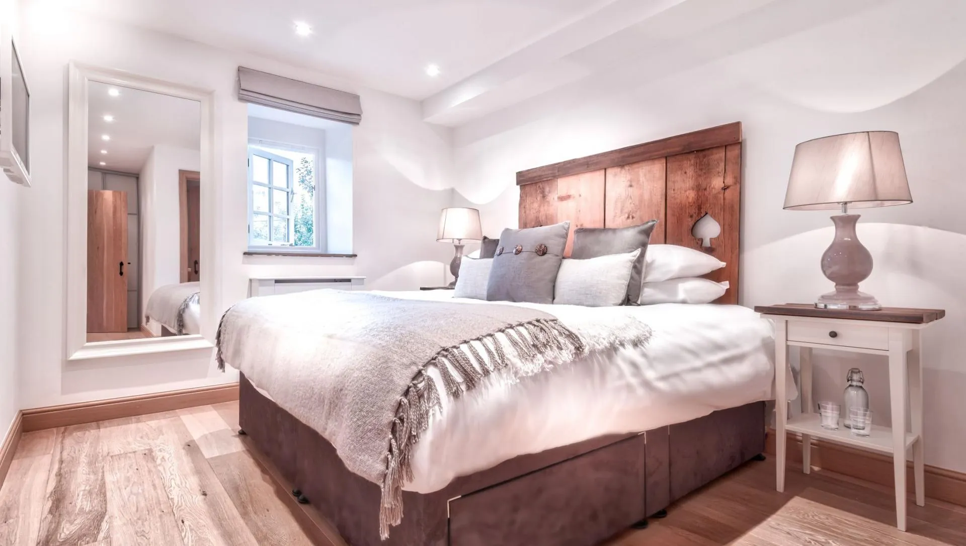 Guest bedroom with super king zip-and-link bed and reclaimed wood headboard
