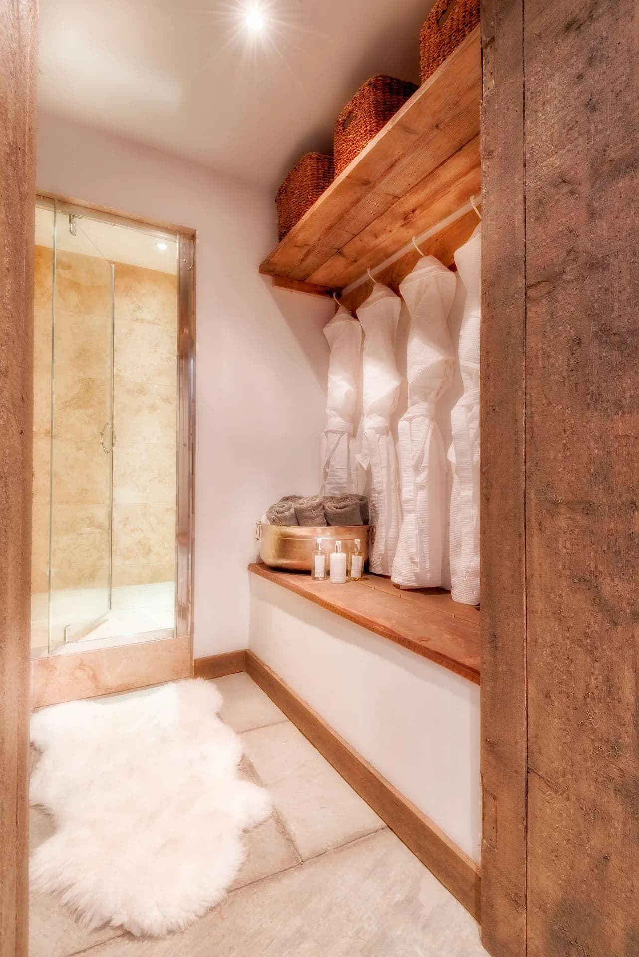 Bathroom dressing area with walk-in shower and provided robes