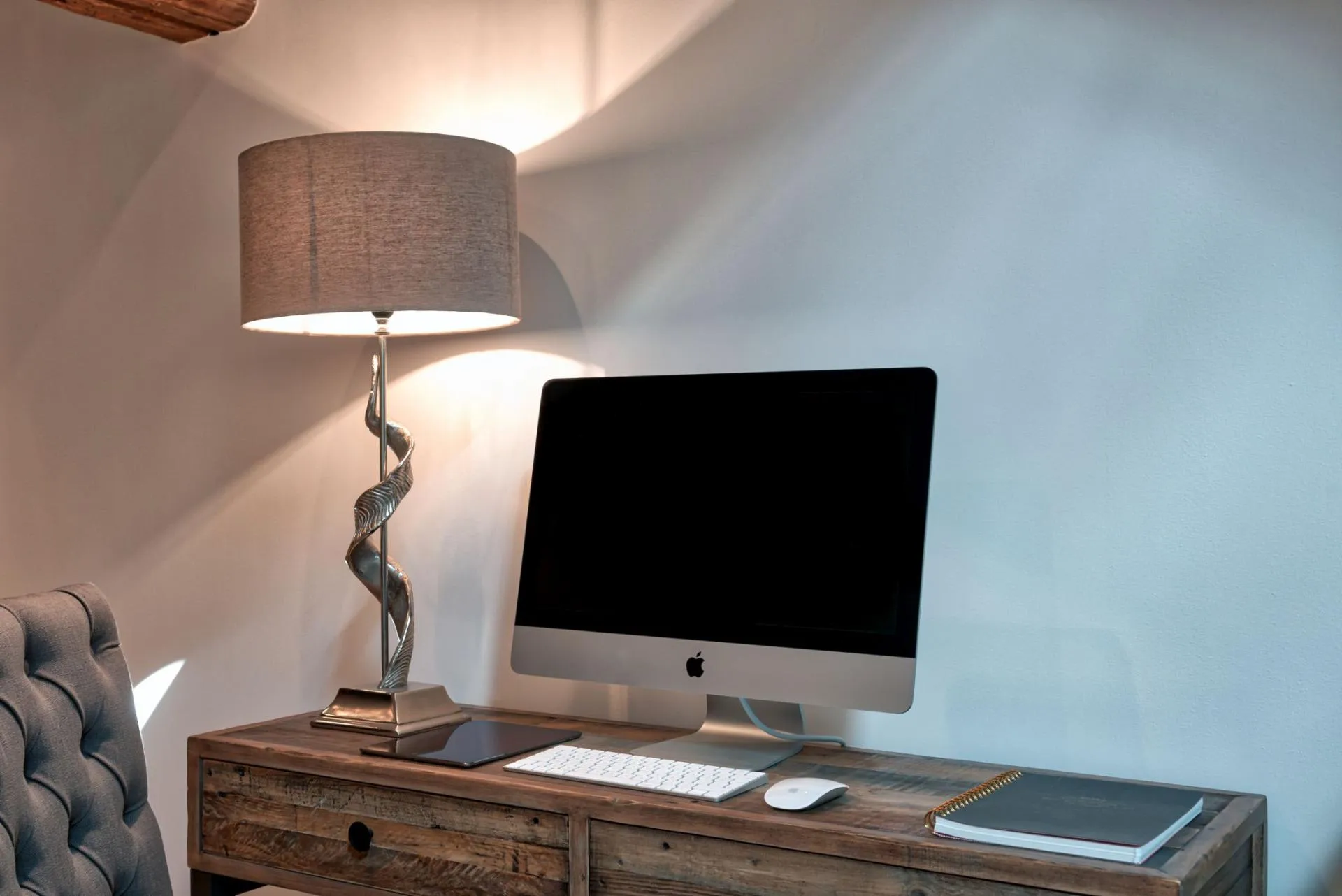 Dedicated workspace with iMac, wireless keyboard, and rustic timber desk