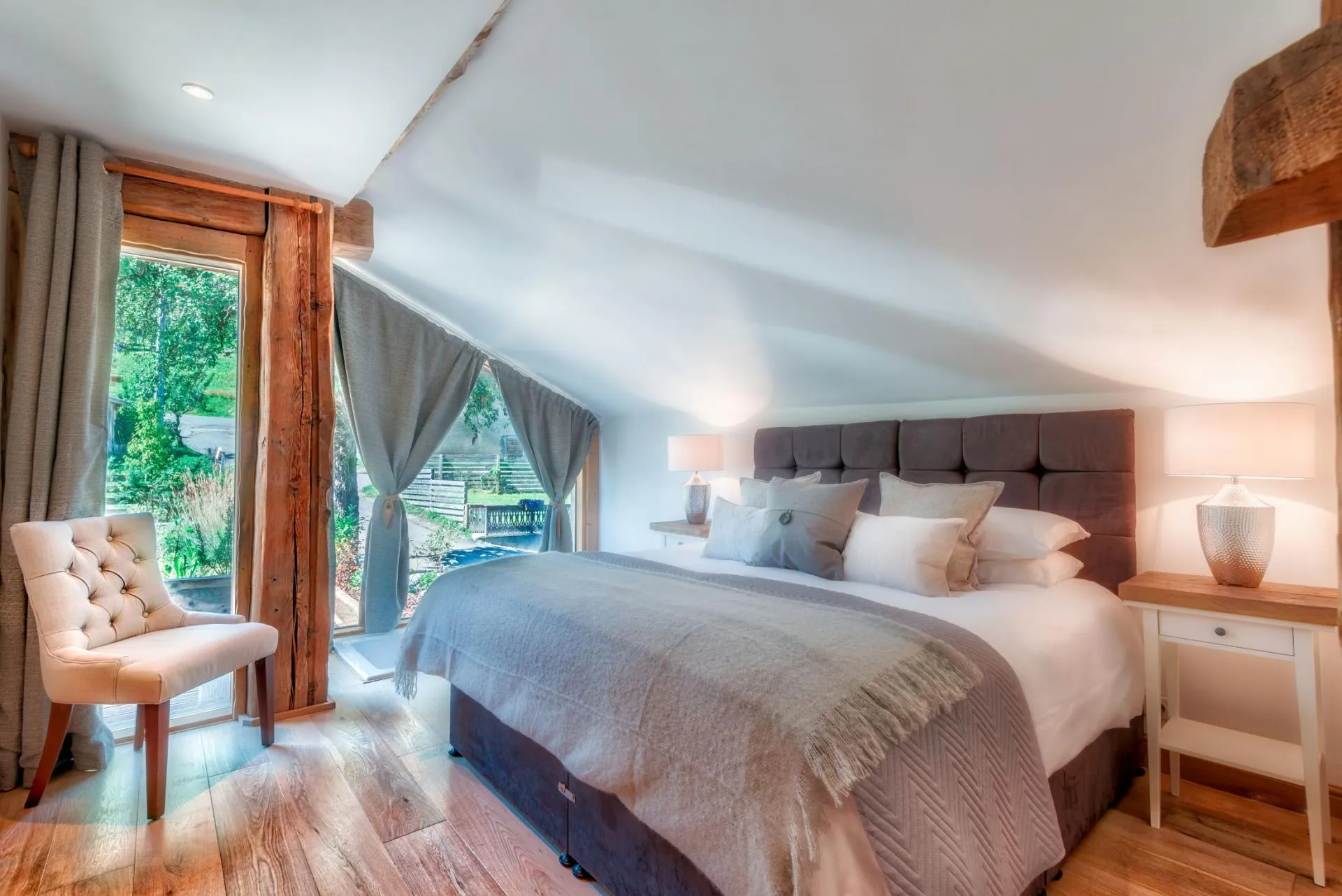Upper-level bedroom with king bed and floor-to-ceiling windows