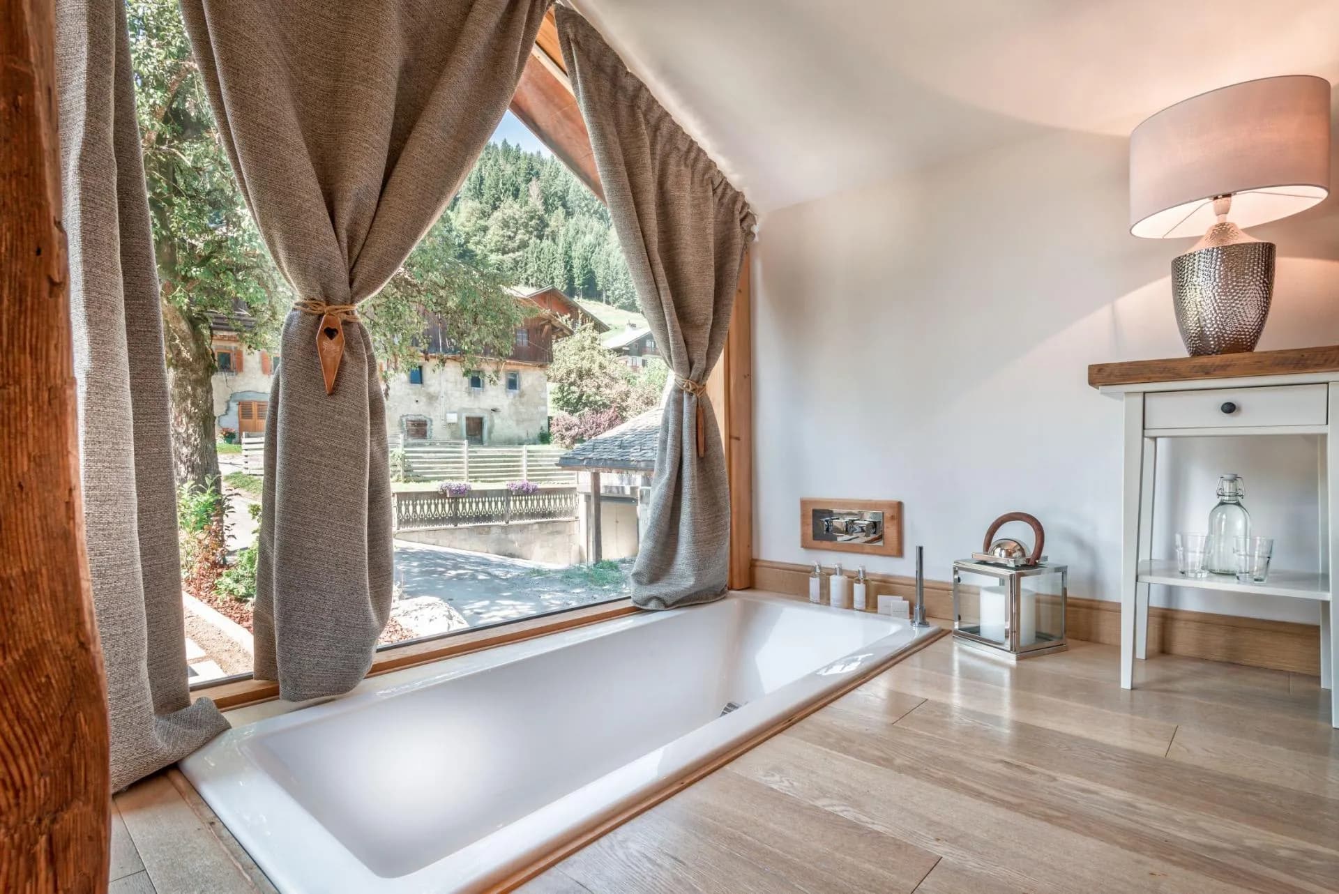 Sunken soaking tub with forest and village views