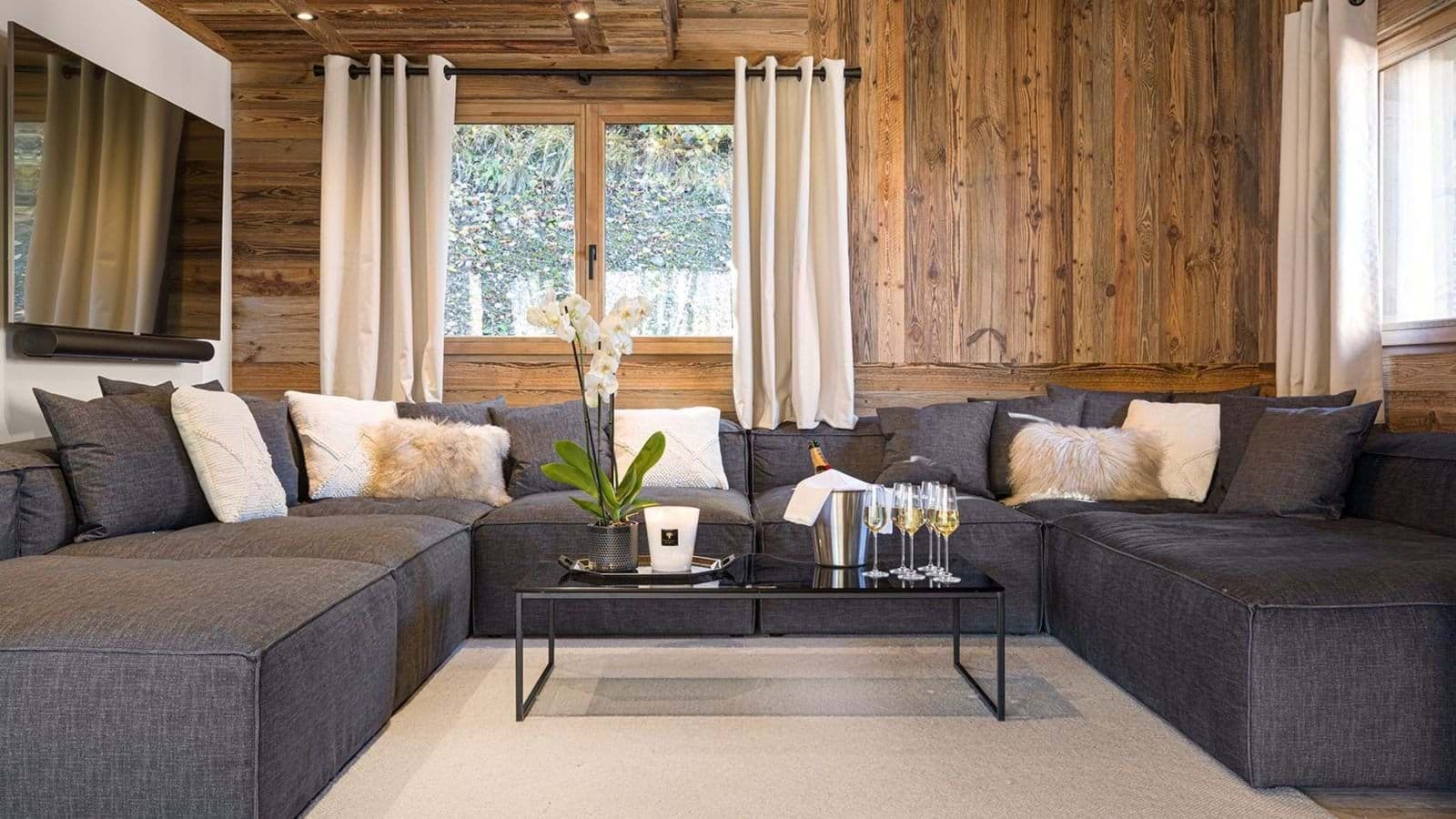 Living area with large sectional seating and wall-mounted smart TV