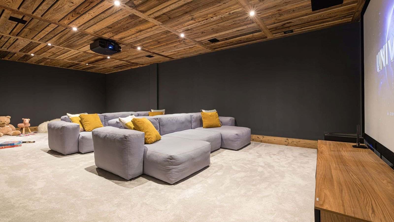 Media room with projector, screen, and modular lounge seating