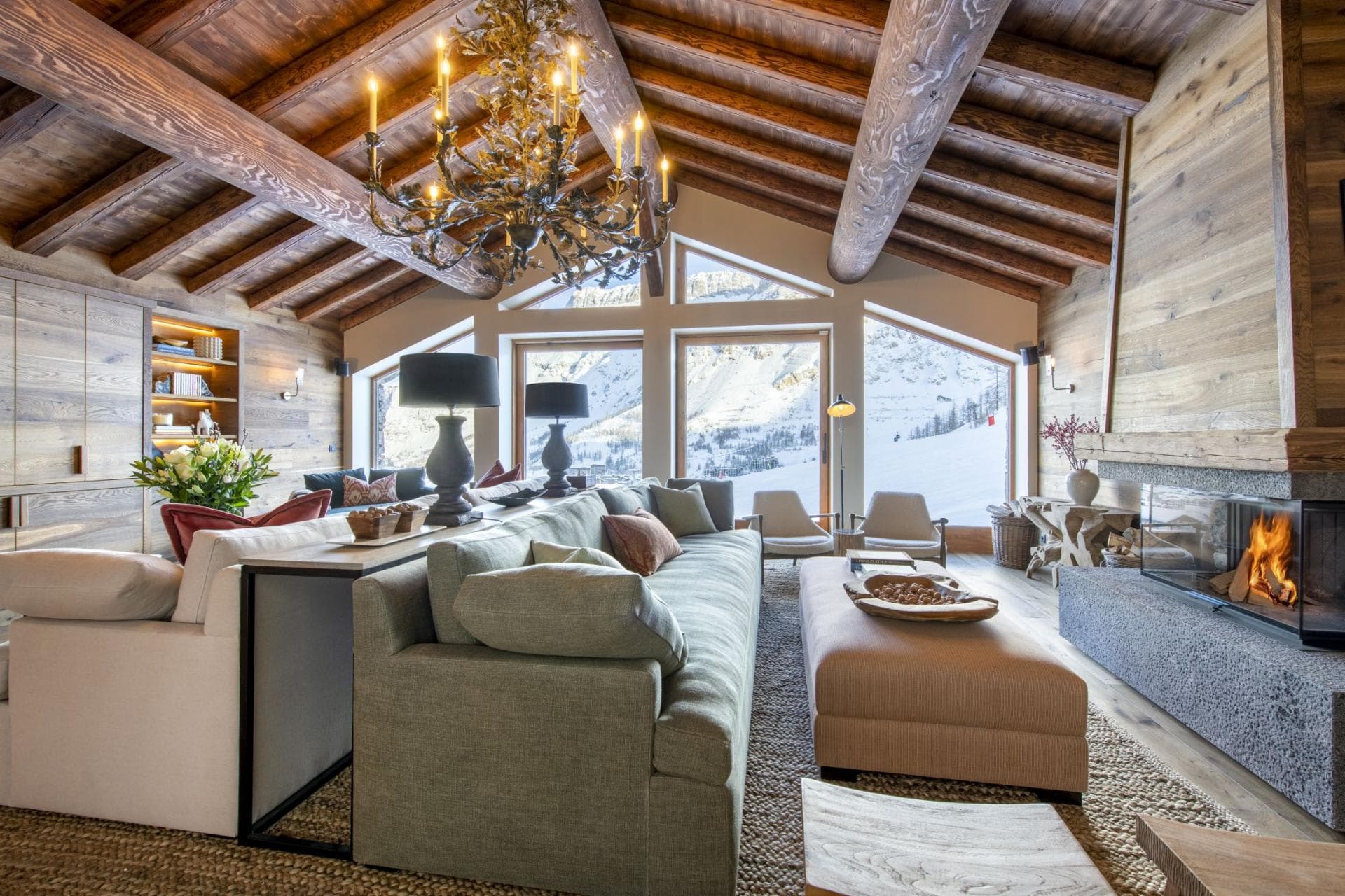 Living area with vaulted log ceilings and ski slope views
