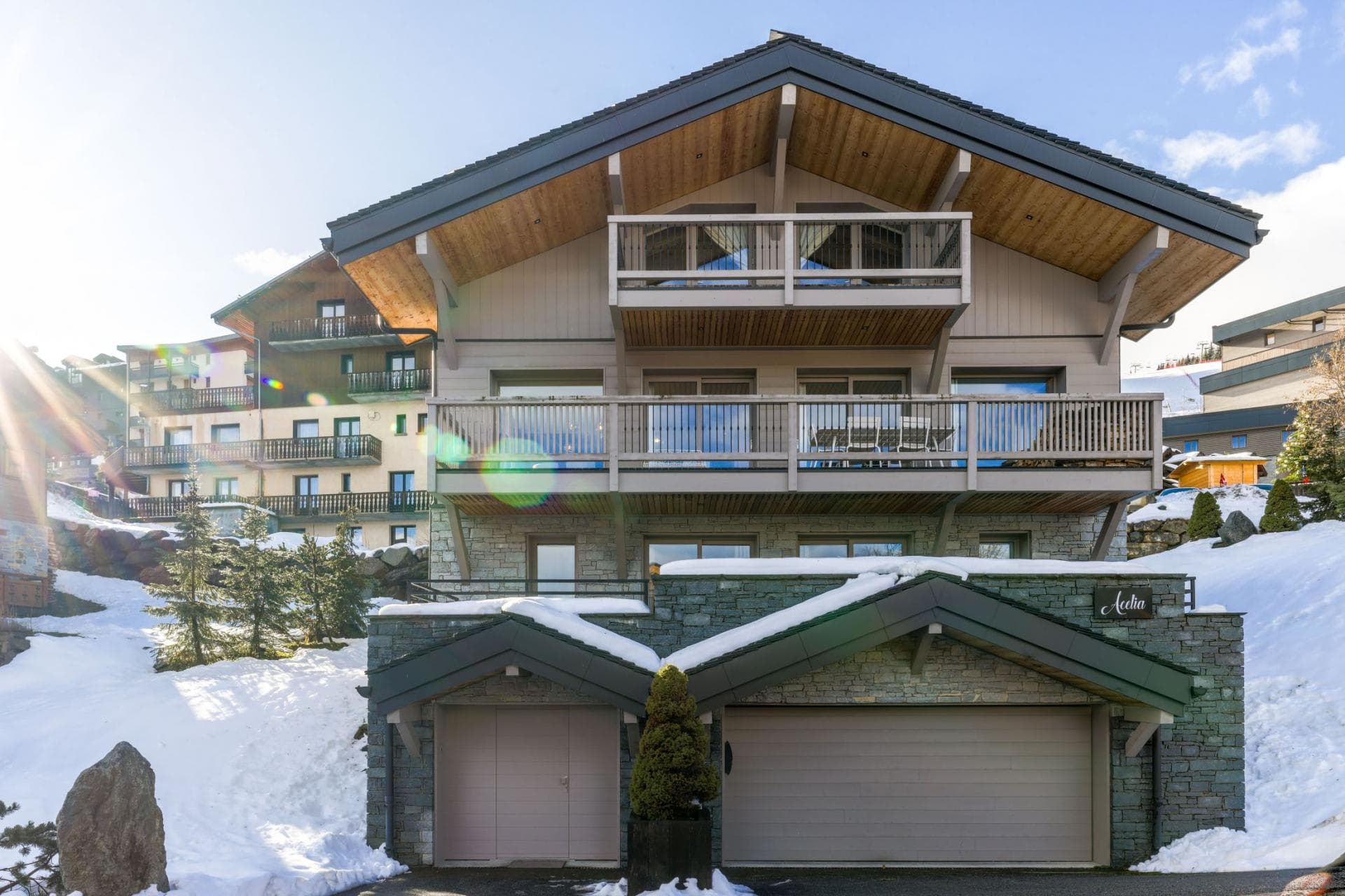 Chalet exterior with two-car garage and private balconies overlooking slopes