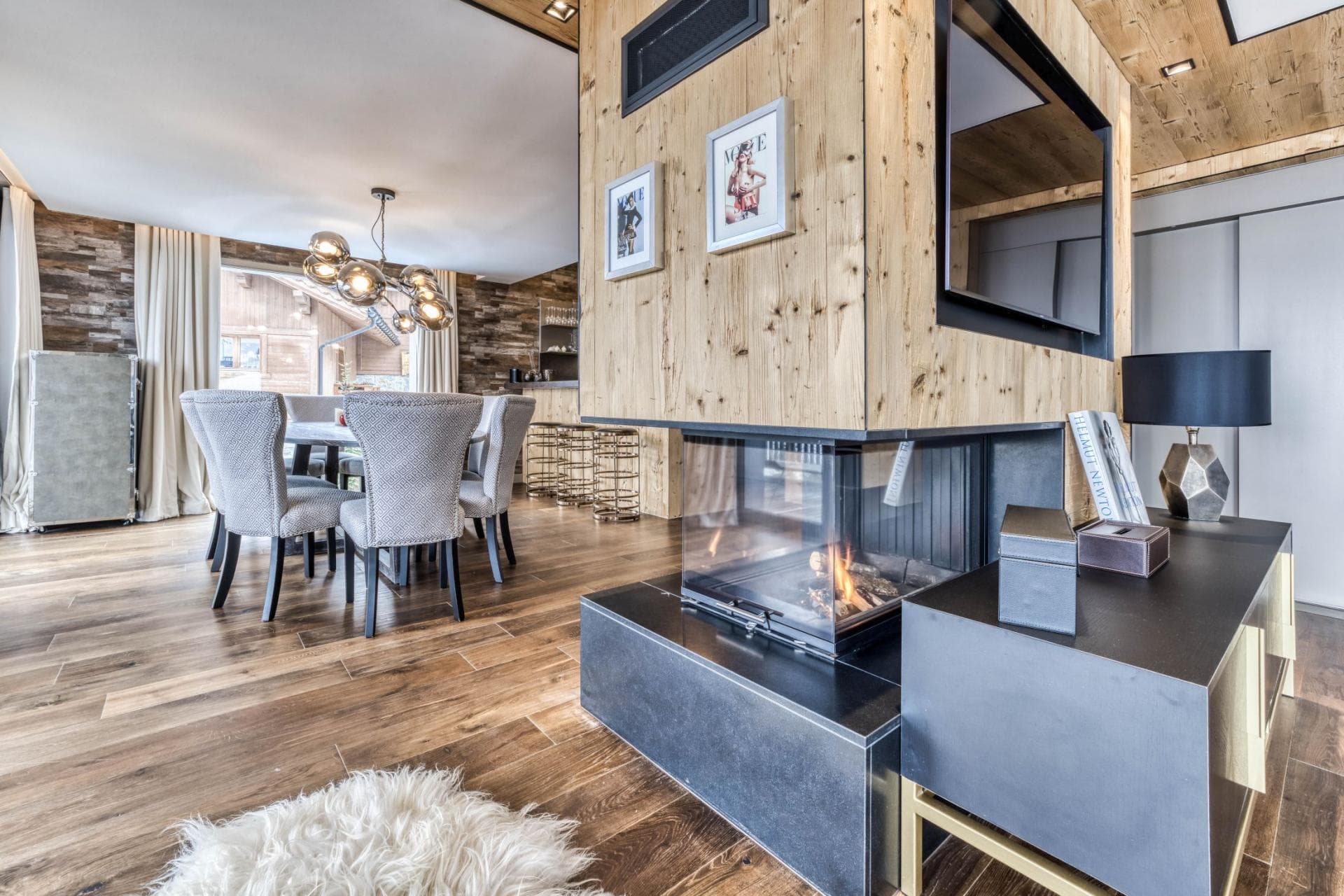 Open-plan dining area with 3-sided glass fireplace and seating for 6