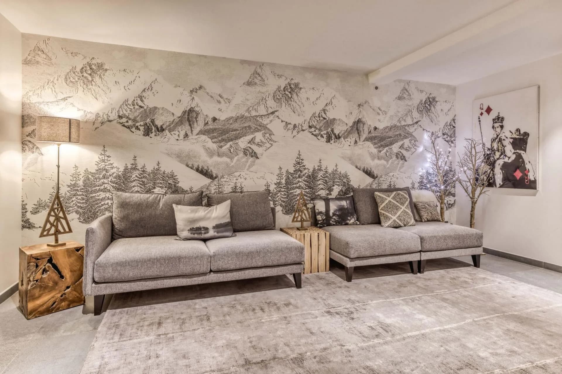 Seating area with a sofa and mountain mural