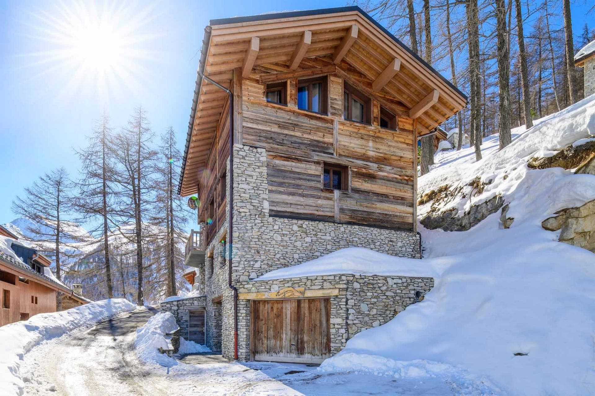 Ski-in chalet with integrated garage and stone-clad exterior