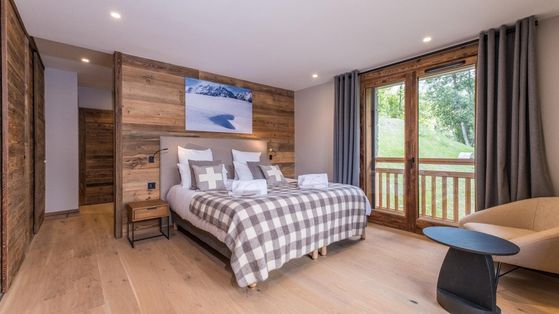 Primary bedroom with king bed, balcony access, and built-in wardrobes