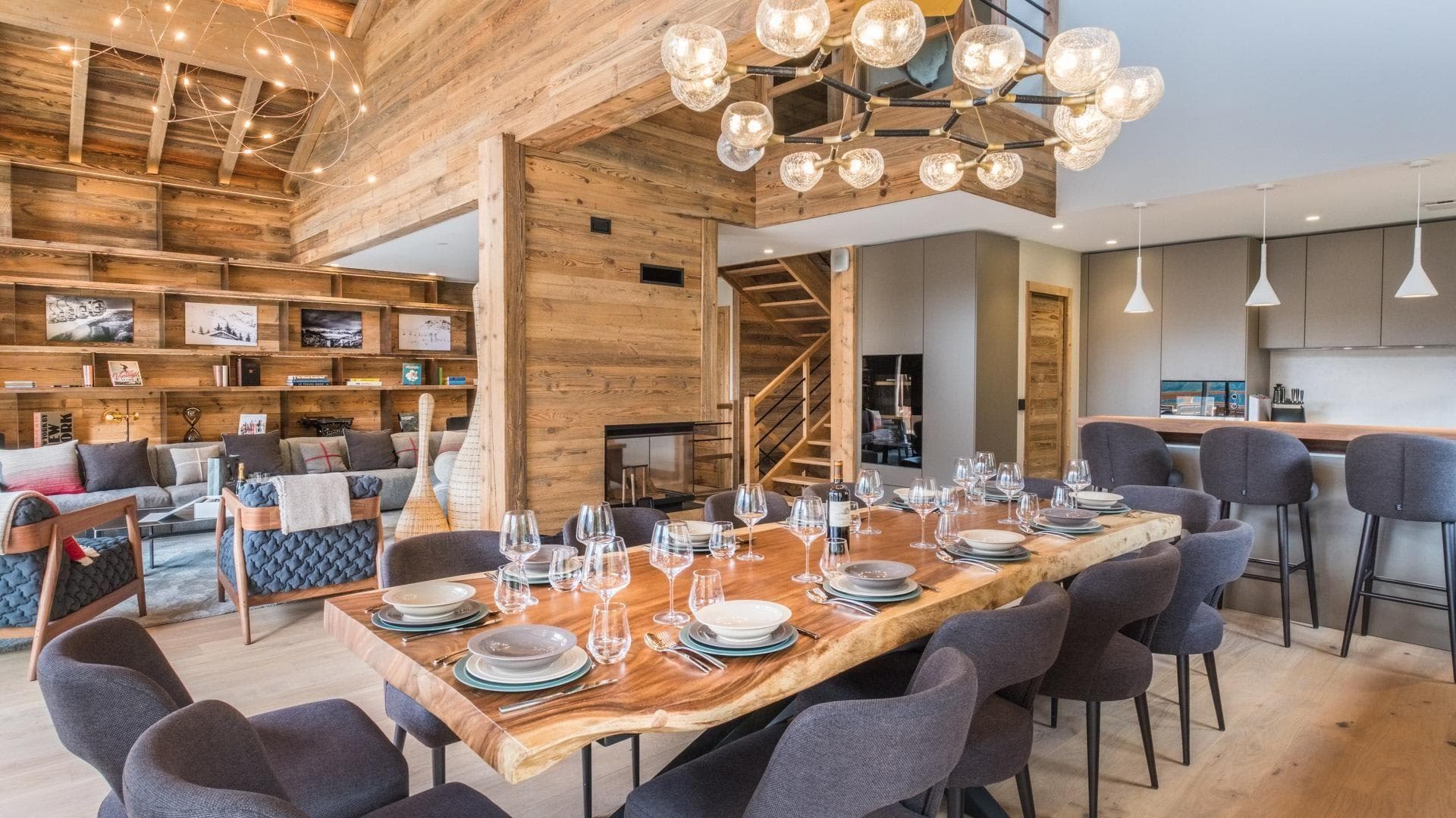 Open-plan dining area seats 12; live-edge table and adjacent breakfast bar