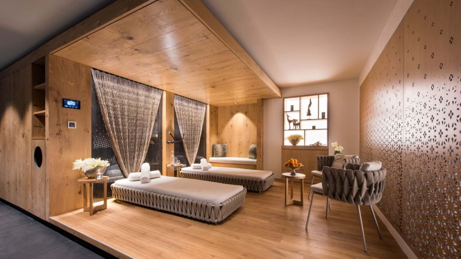 Spa relaxation room featuring twin loungers and integrated wood canopy