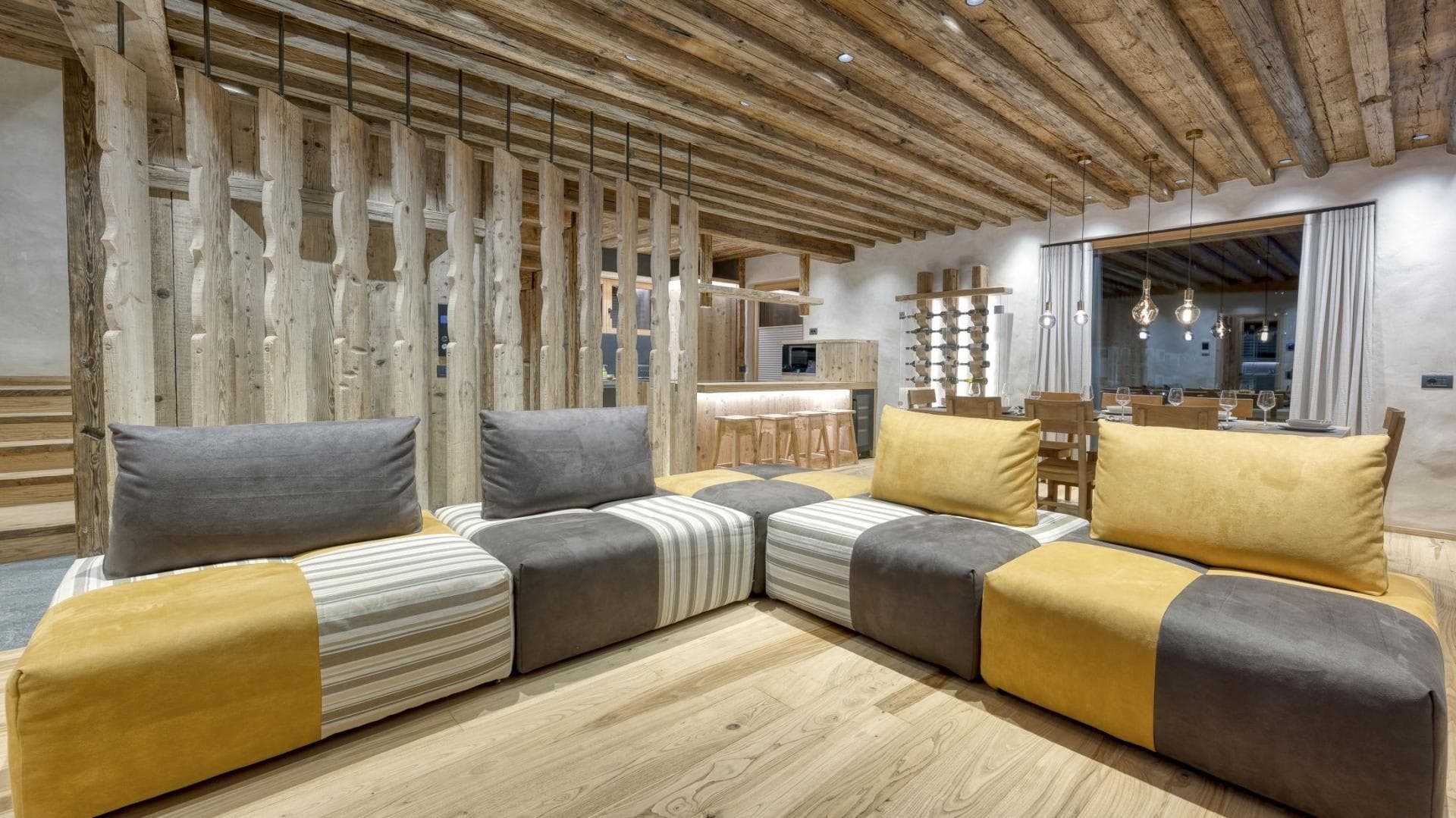 Open living area featuring modular sectional seating and built-in wine rack