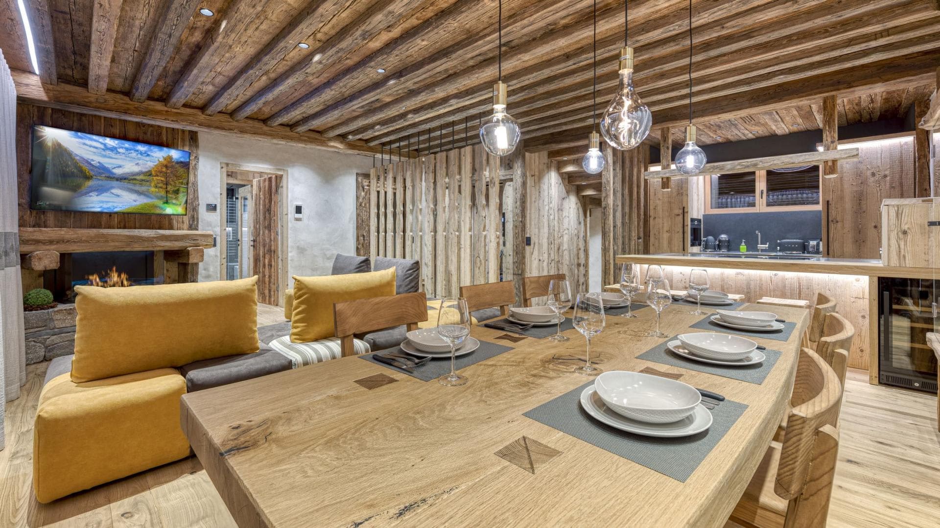 Open-plan dining area with seating for 8 and reclaimed wood ceilings