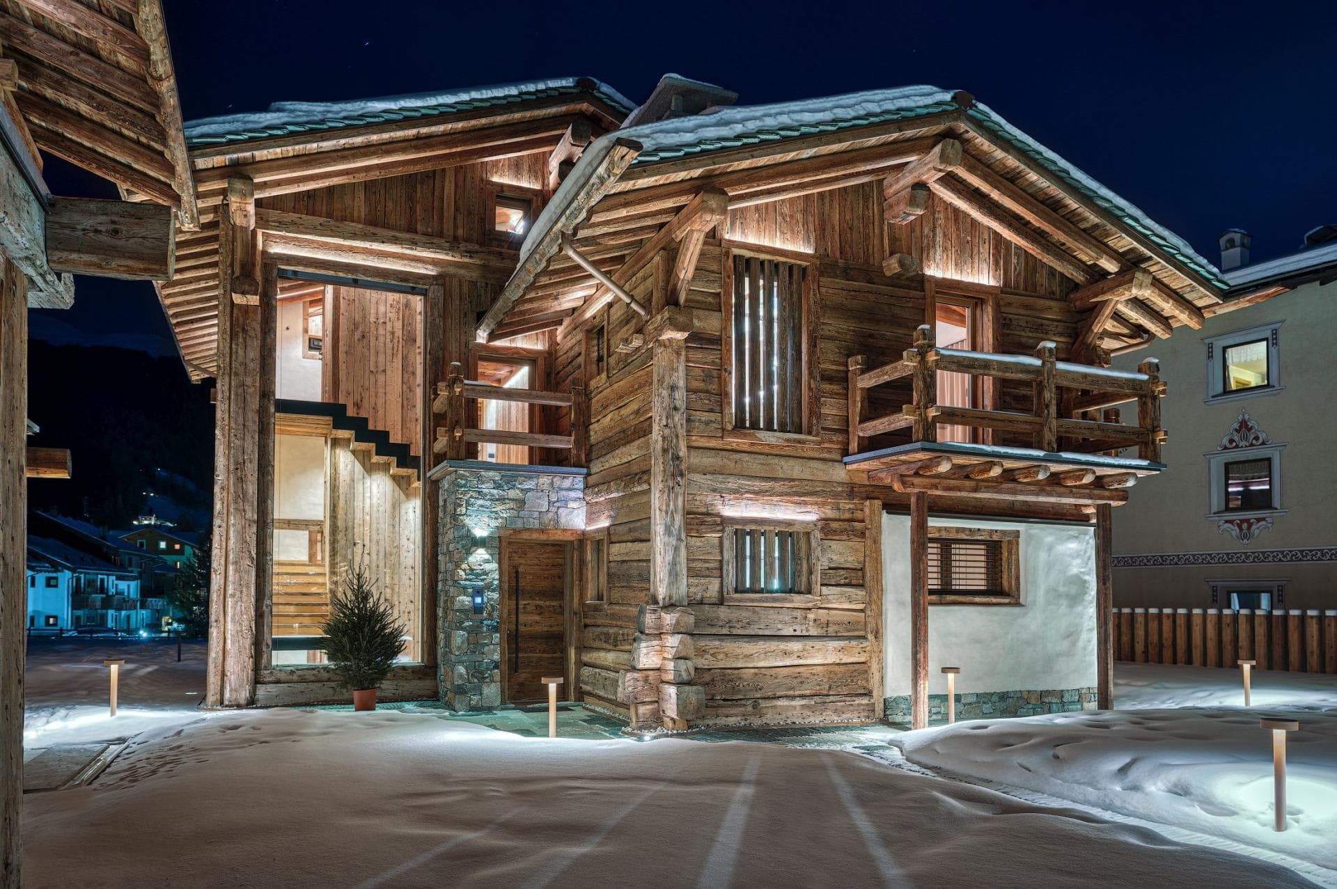 Chalet exterior with timber construction and private second-floor balcony
