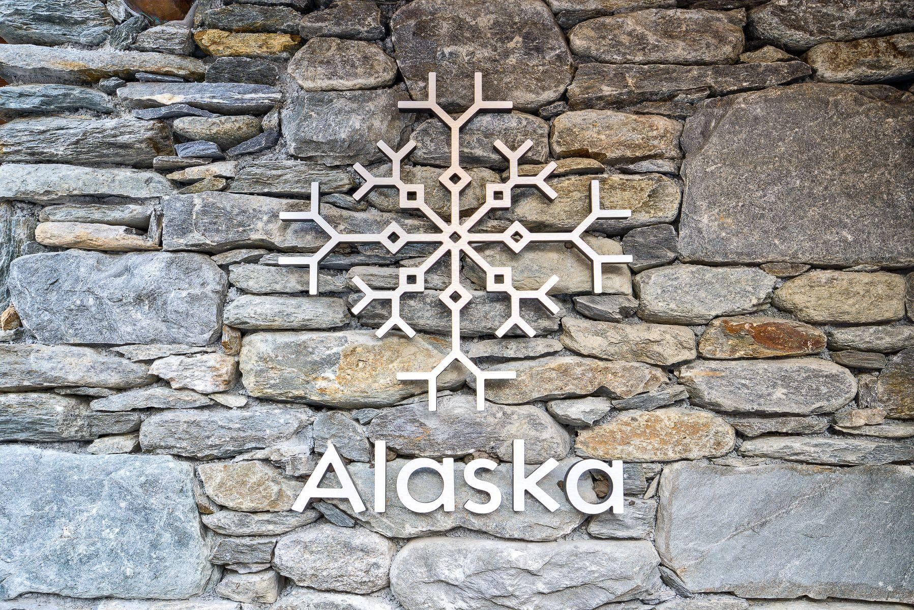 Stone masonry exterior with snowflake logo and property signage