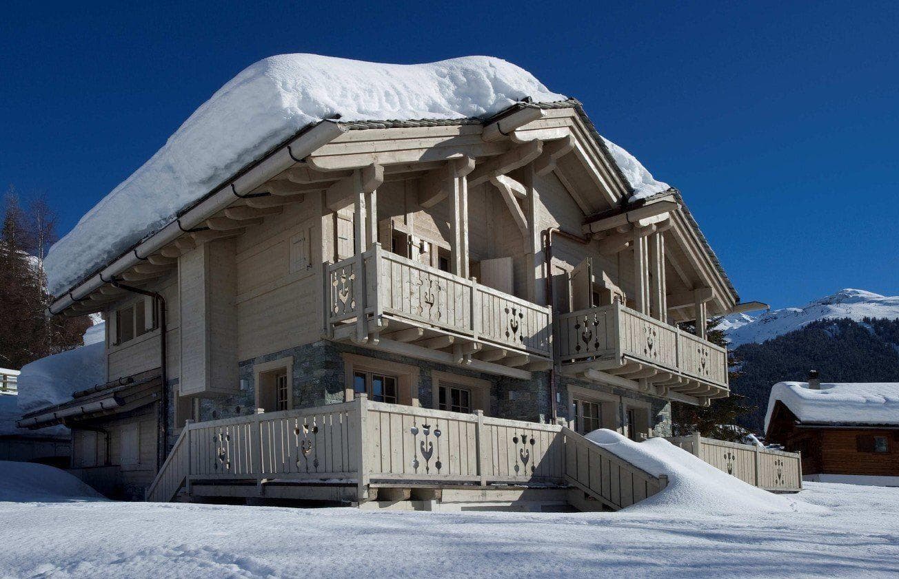 Ski-in chalet exterior with private balconies and wrap-around terrace