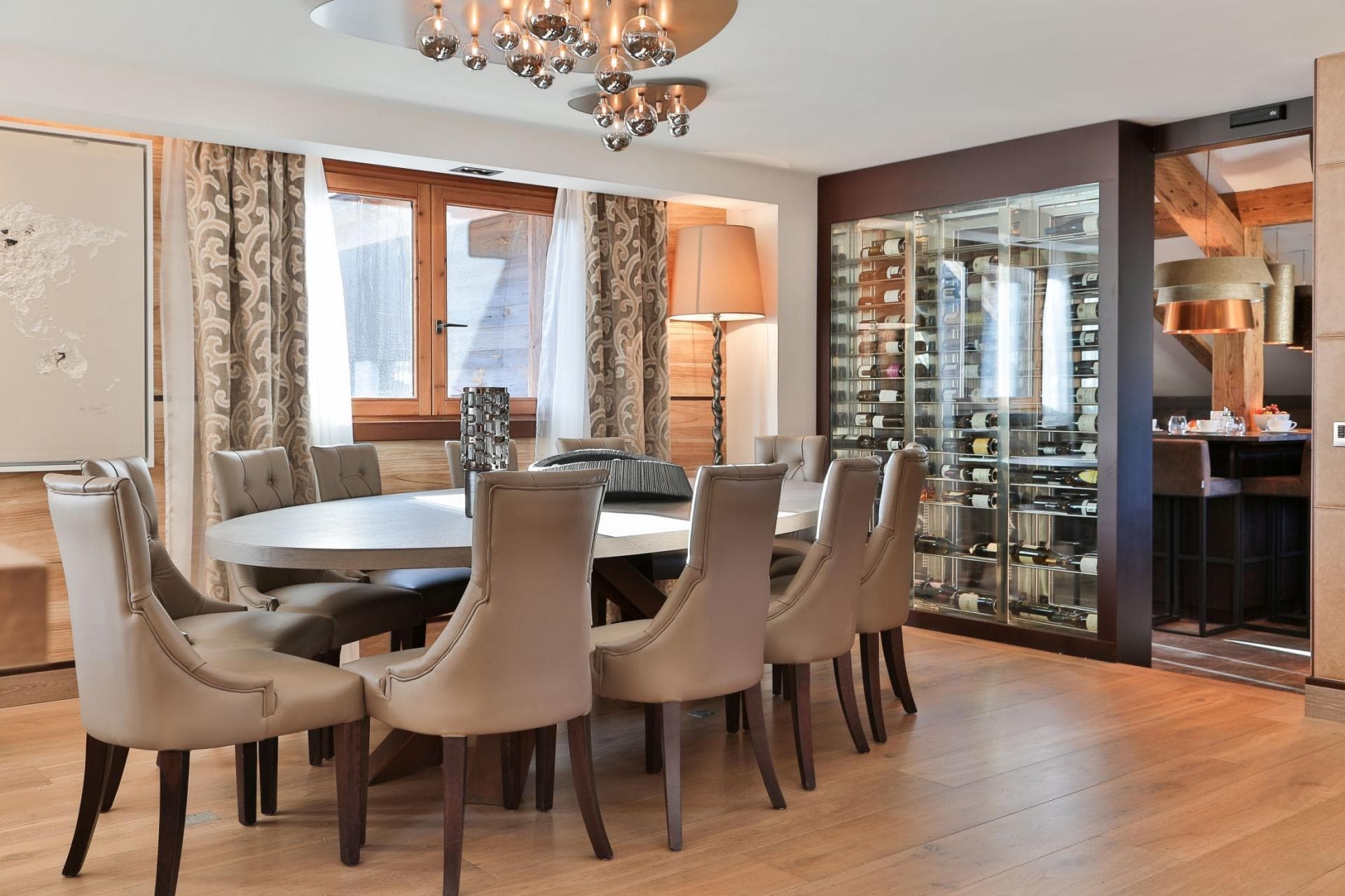 Dining area seats 8 with glass-enclosed wine display