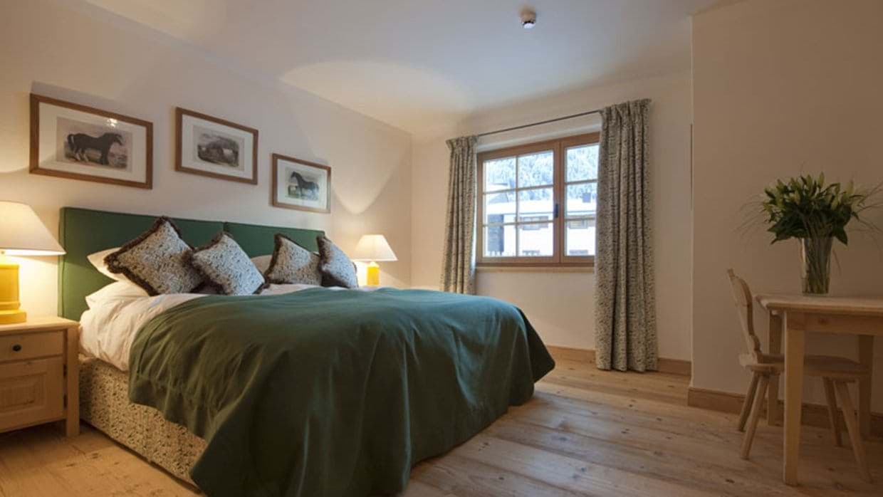 Guest bedroom with king bed and small writing desk