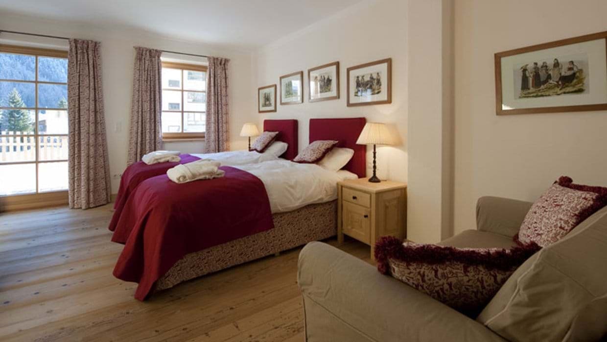 Guest bedroom with two twin beds and balcony access