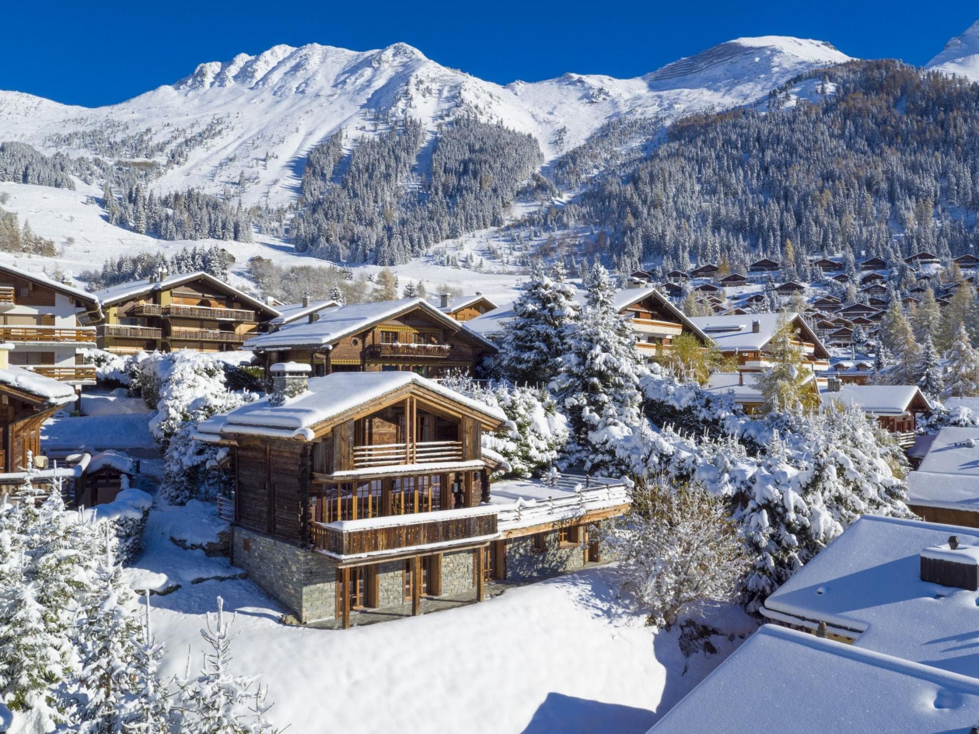 Ski-in chalet with wrap-around balconies and mountain views