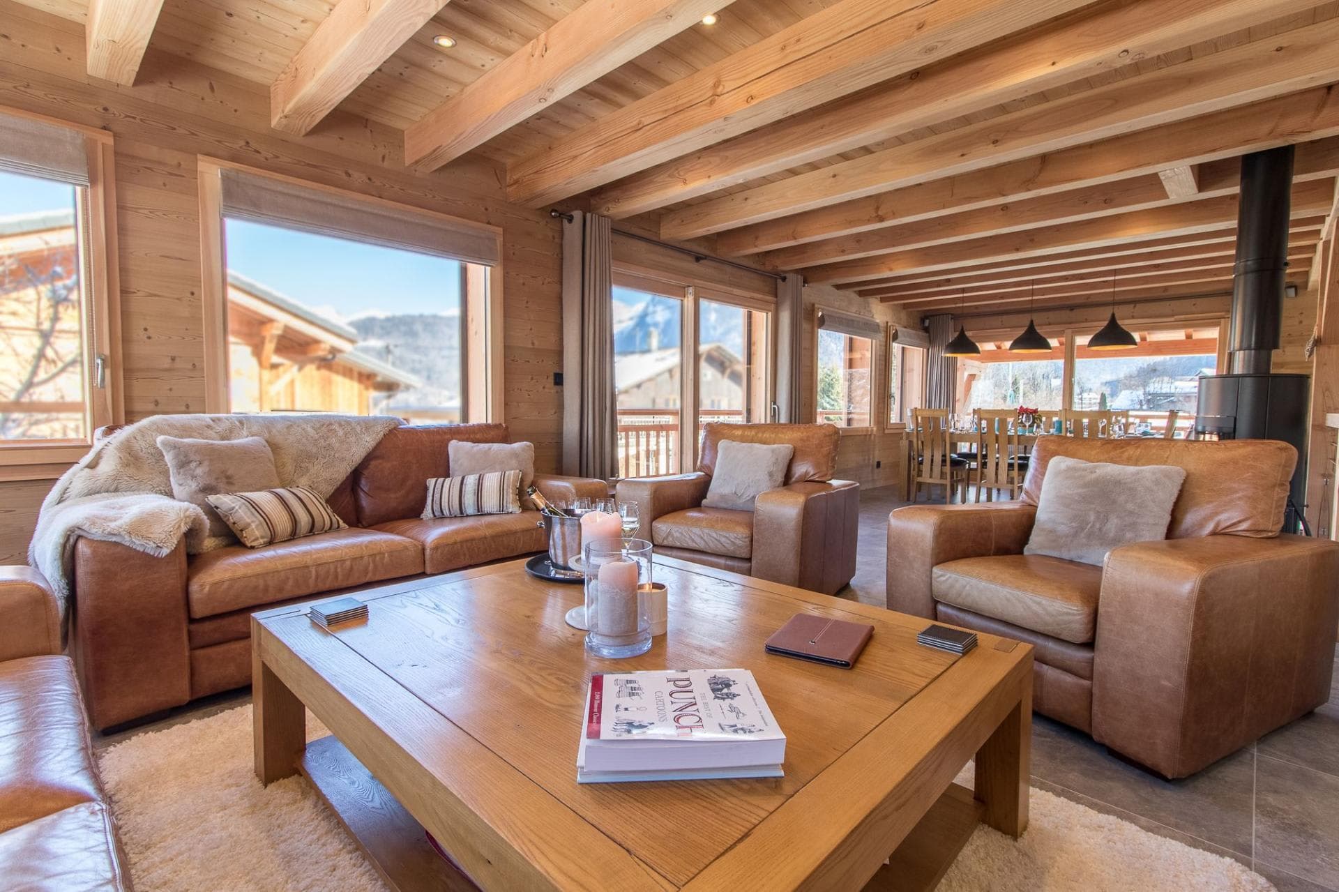 Open-plan living area with wood-burning stove and mountain views