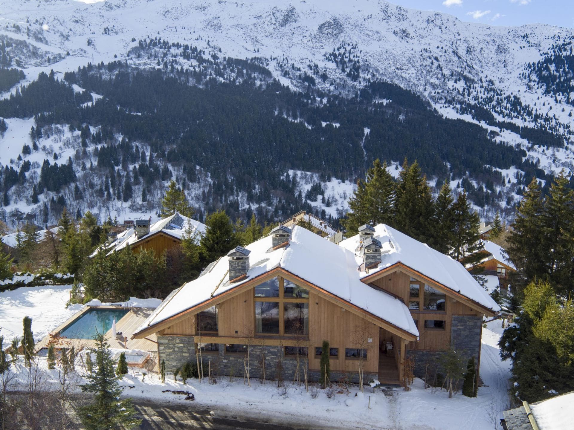Chalet exterior with heated outdoor pool and mountain views