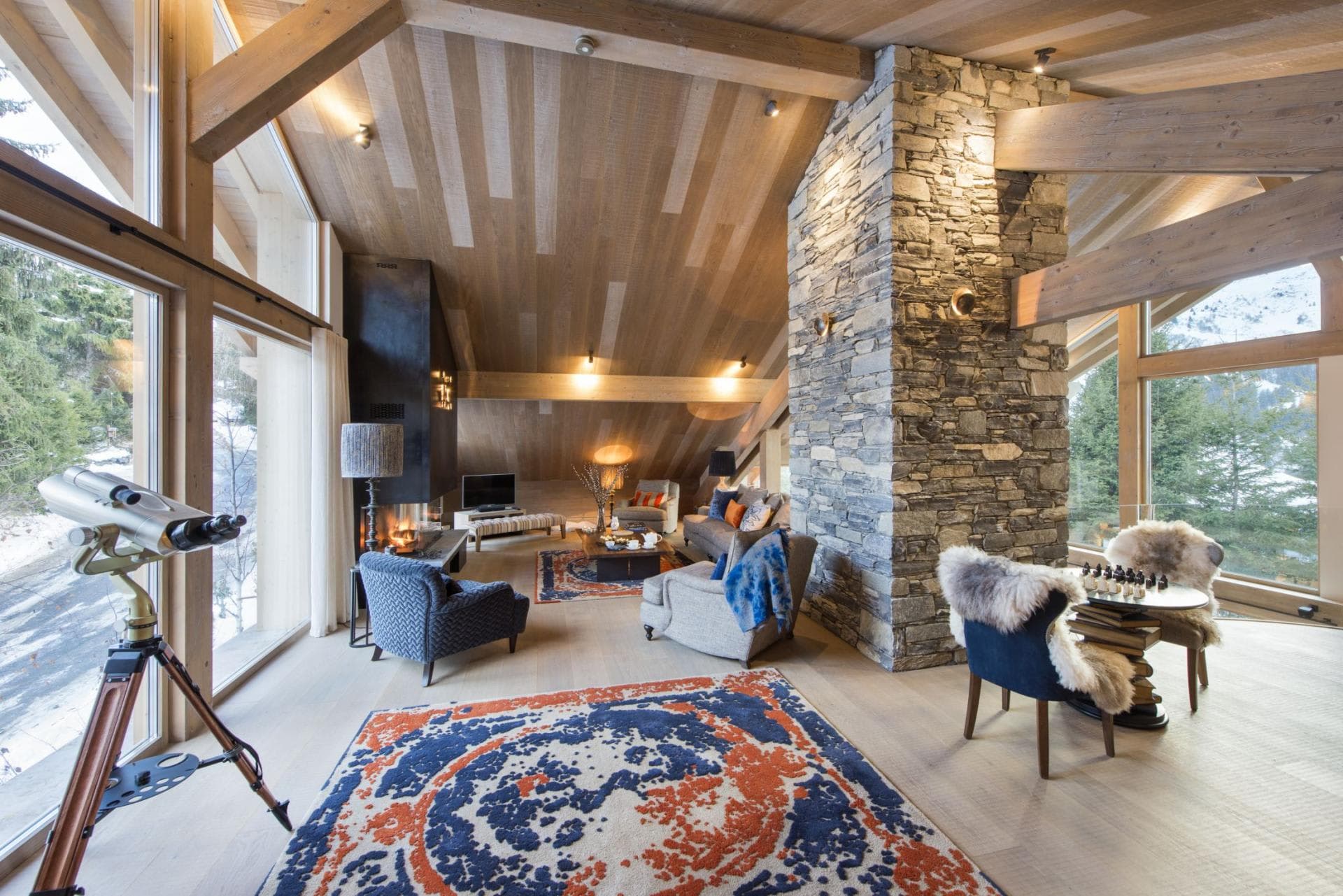 Open living area with wood-burning fireplace and stargazing telescope