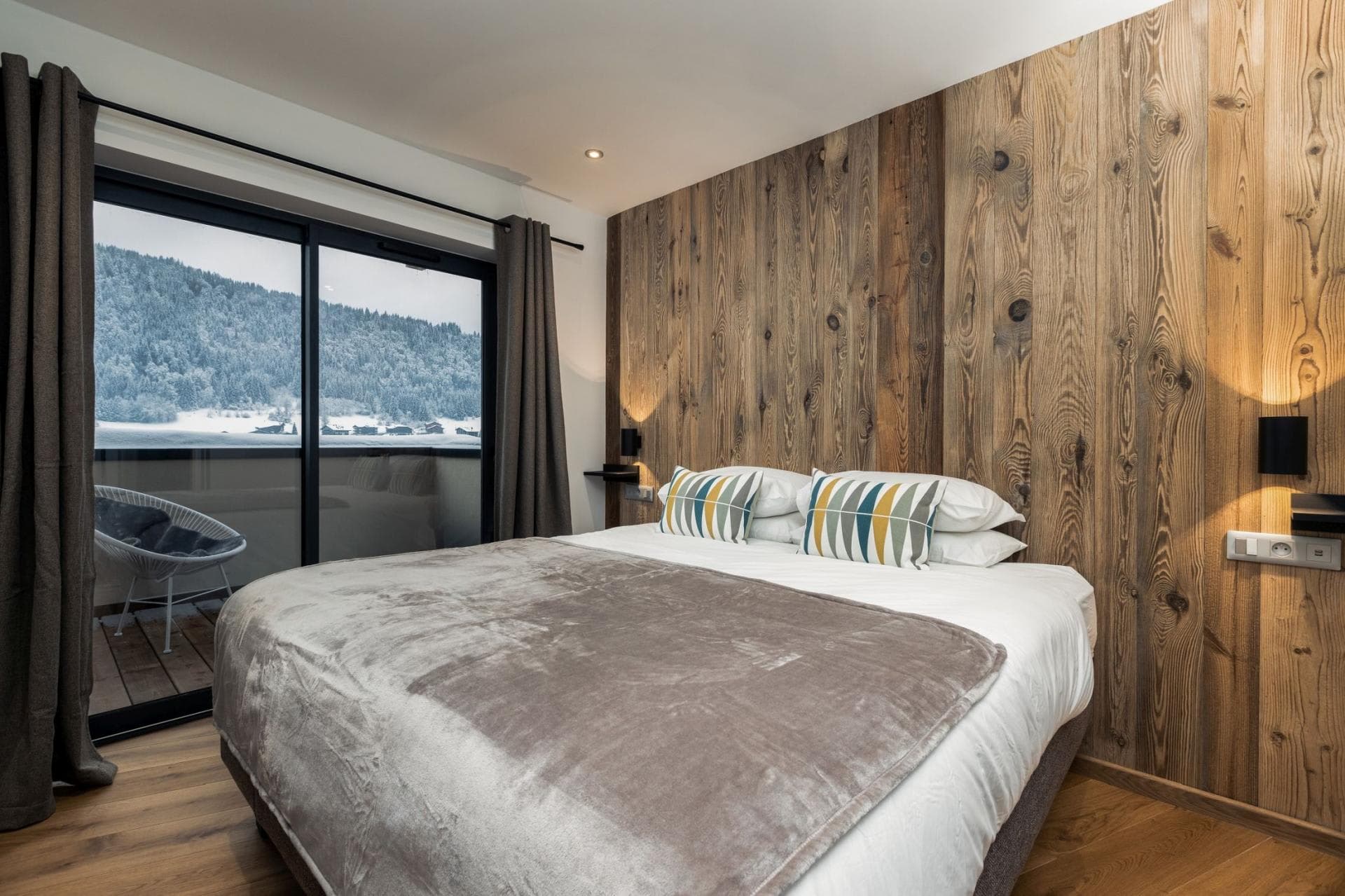 Primary bedroom with king bed and balcony access to mountain views