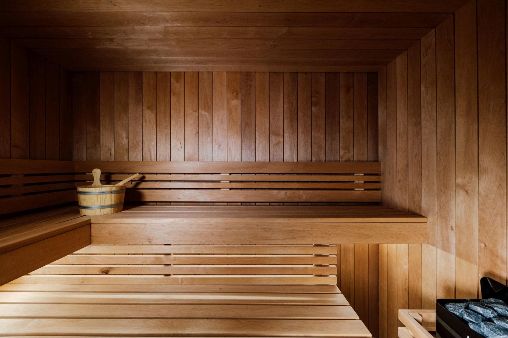 Cedar sauna with two-tier seating and traditional bucket kit