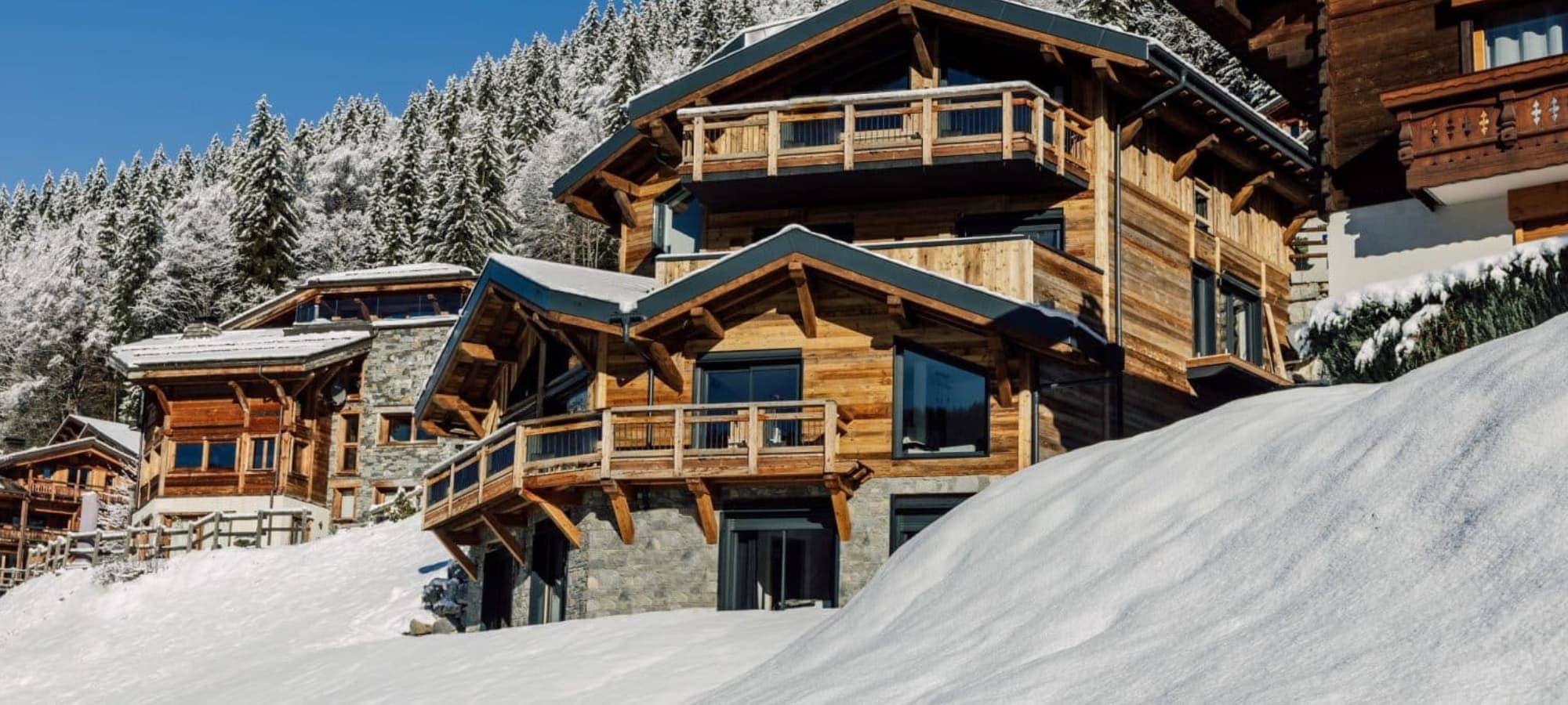 Wood and stone chalet with multiple balconies and direct slope access