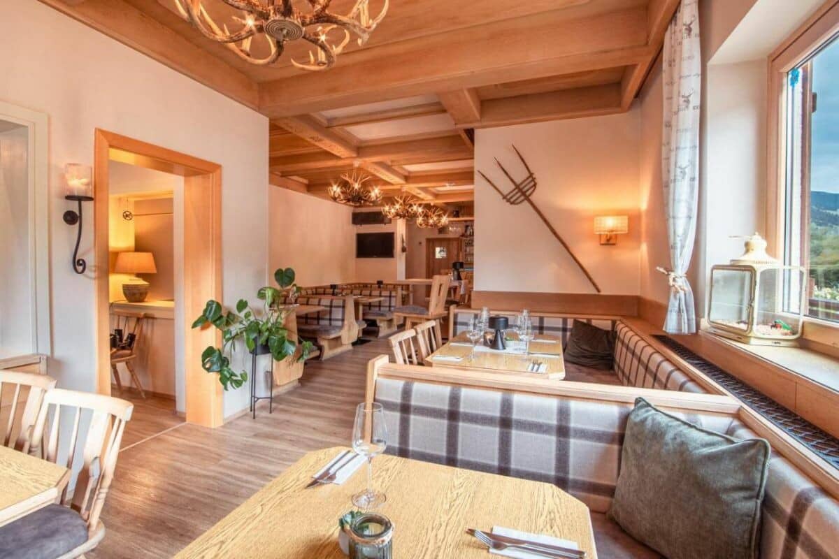 Dining area with banquet seating and antler chandeliers