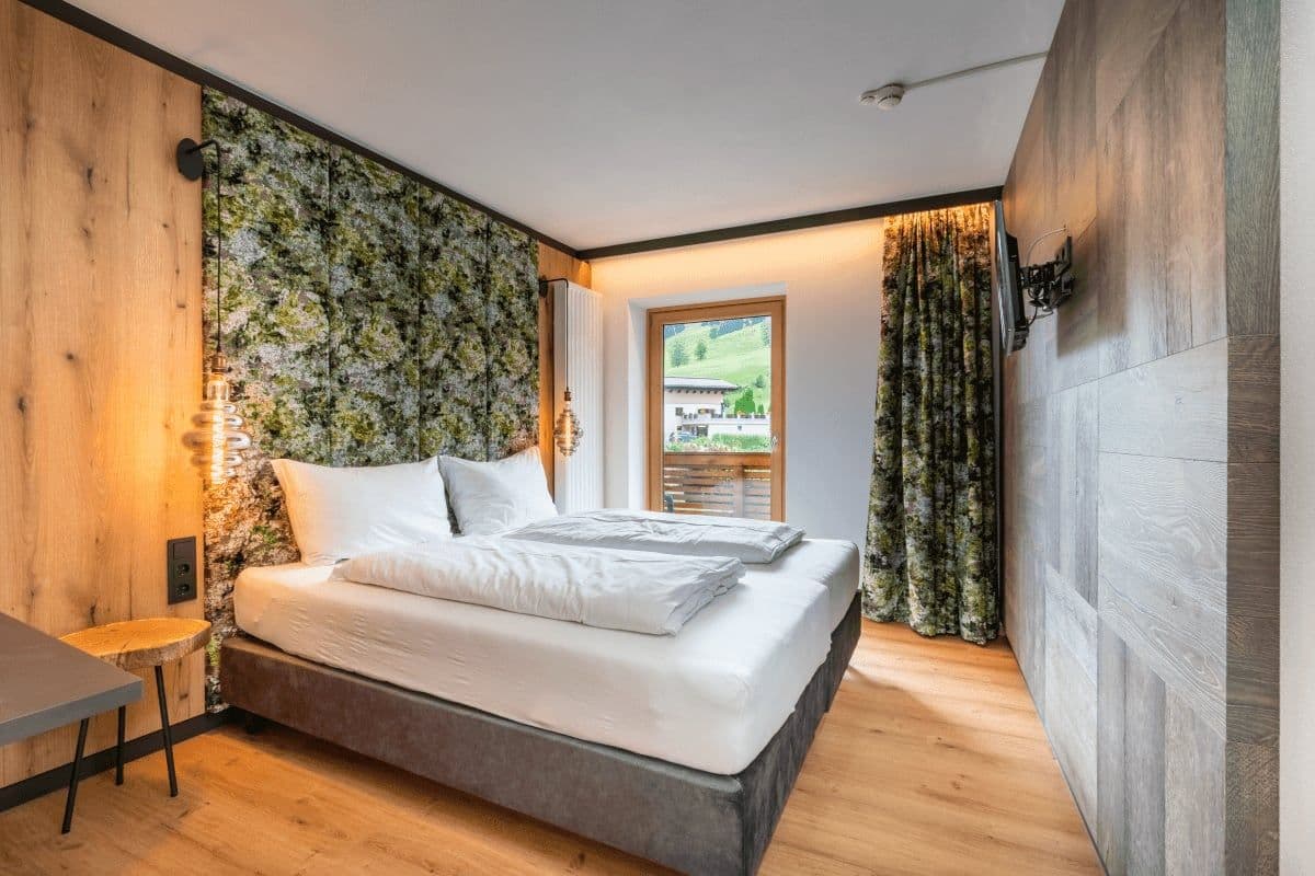 Bedroom with two twin mattresses and balcony access