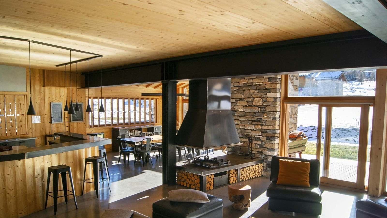 Open living area with wood-burning fireplace and breakfast bar seating