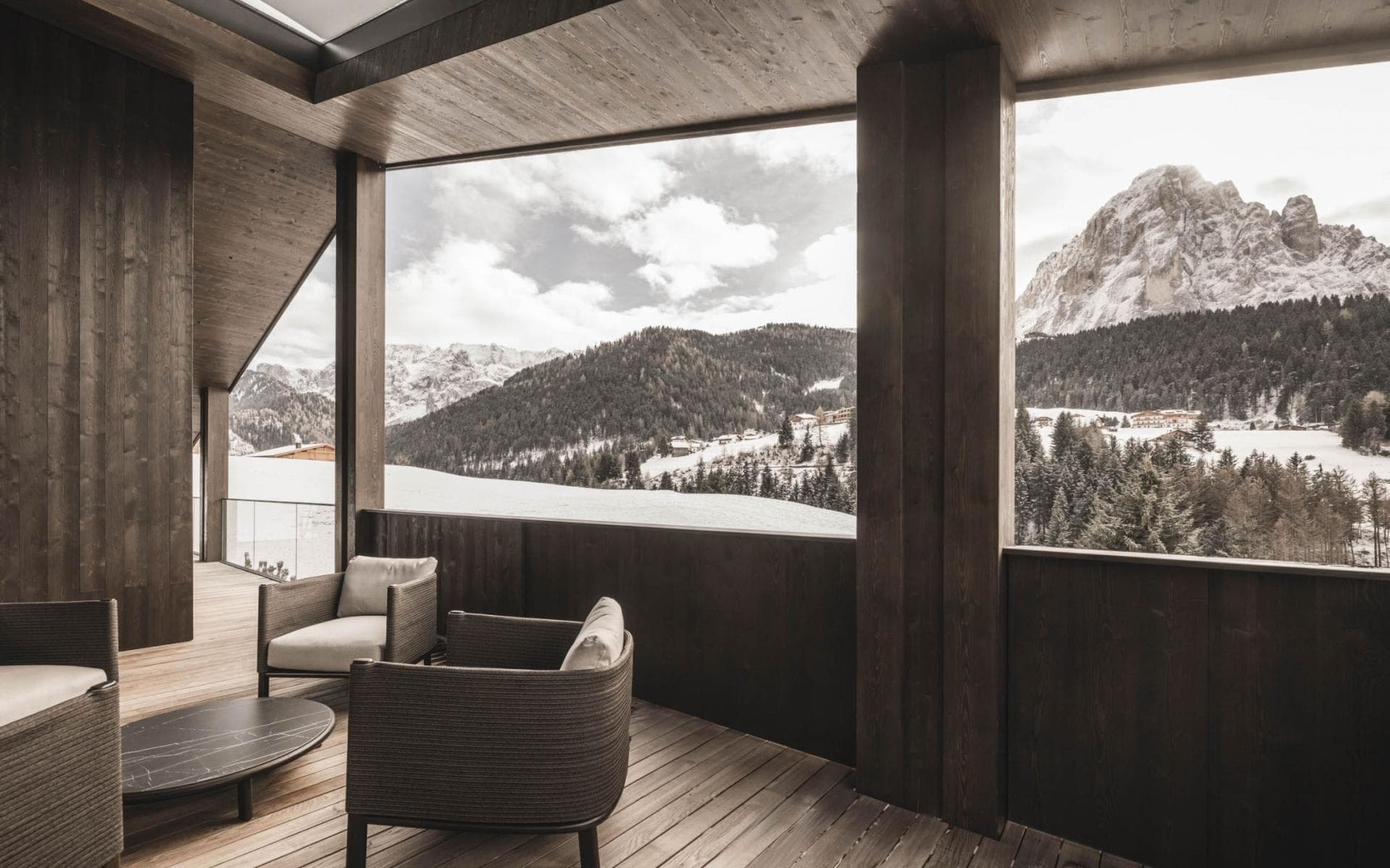 Covered terrace with lounge seating and snow-capped mountain views