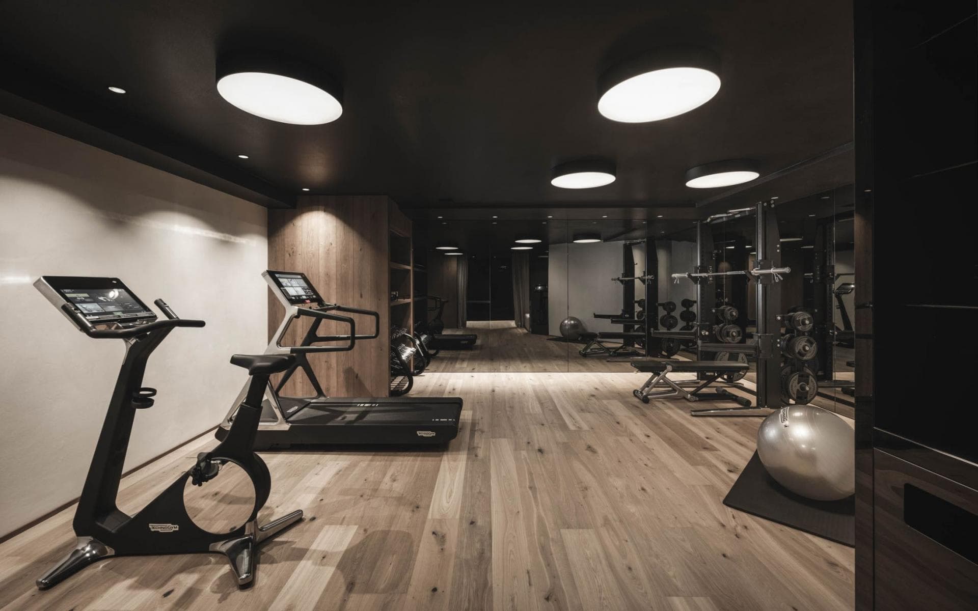 Fitness room with Technogym equipment and squat rack