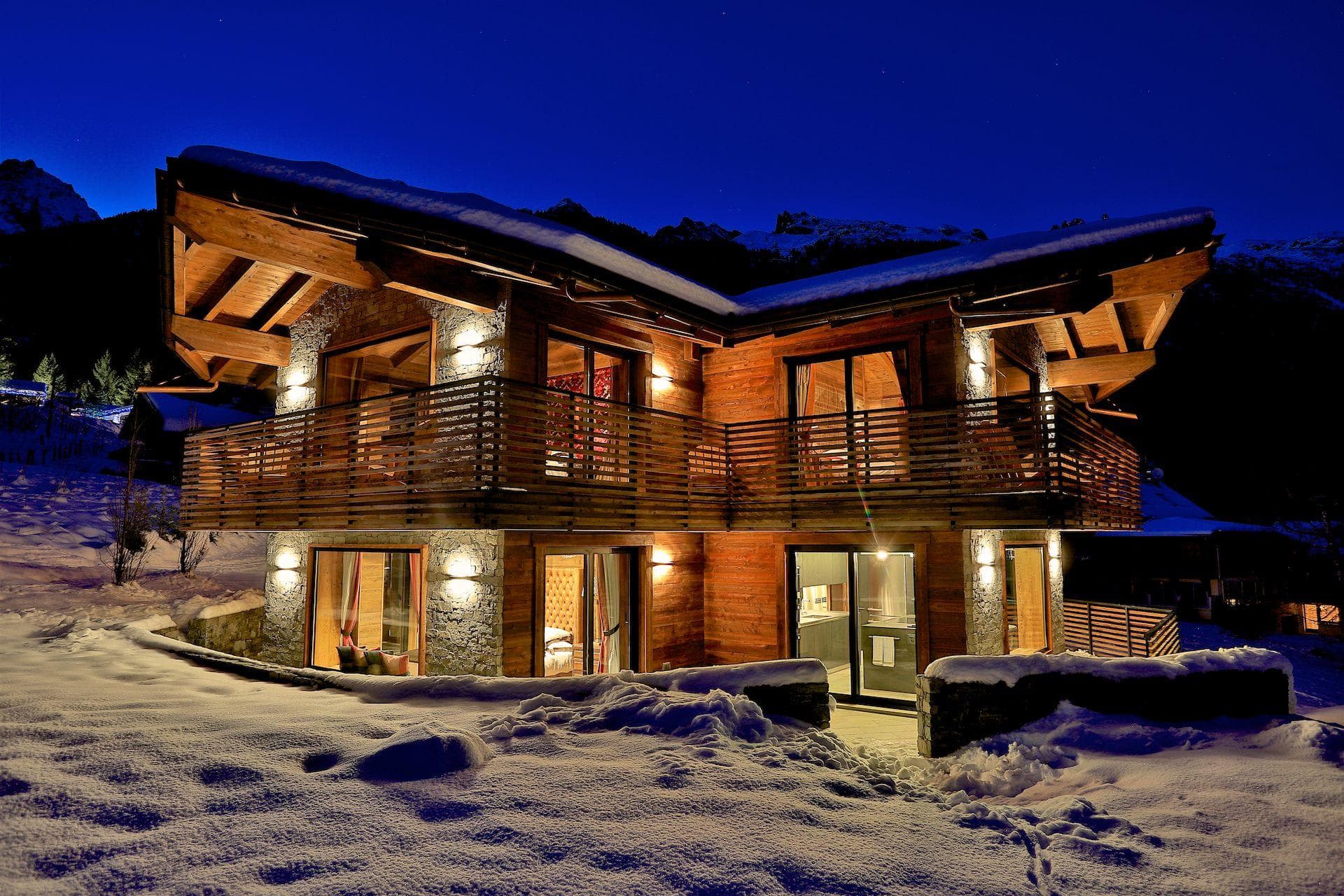 Two-story mountain chalet with wrap-around balconies and ski-in access