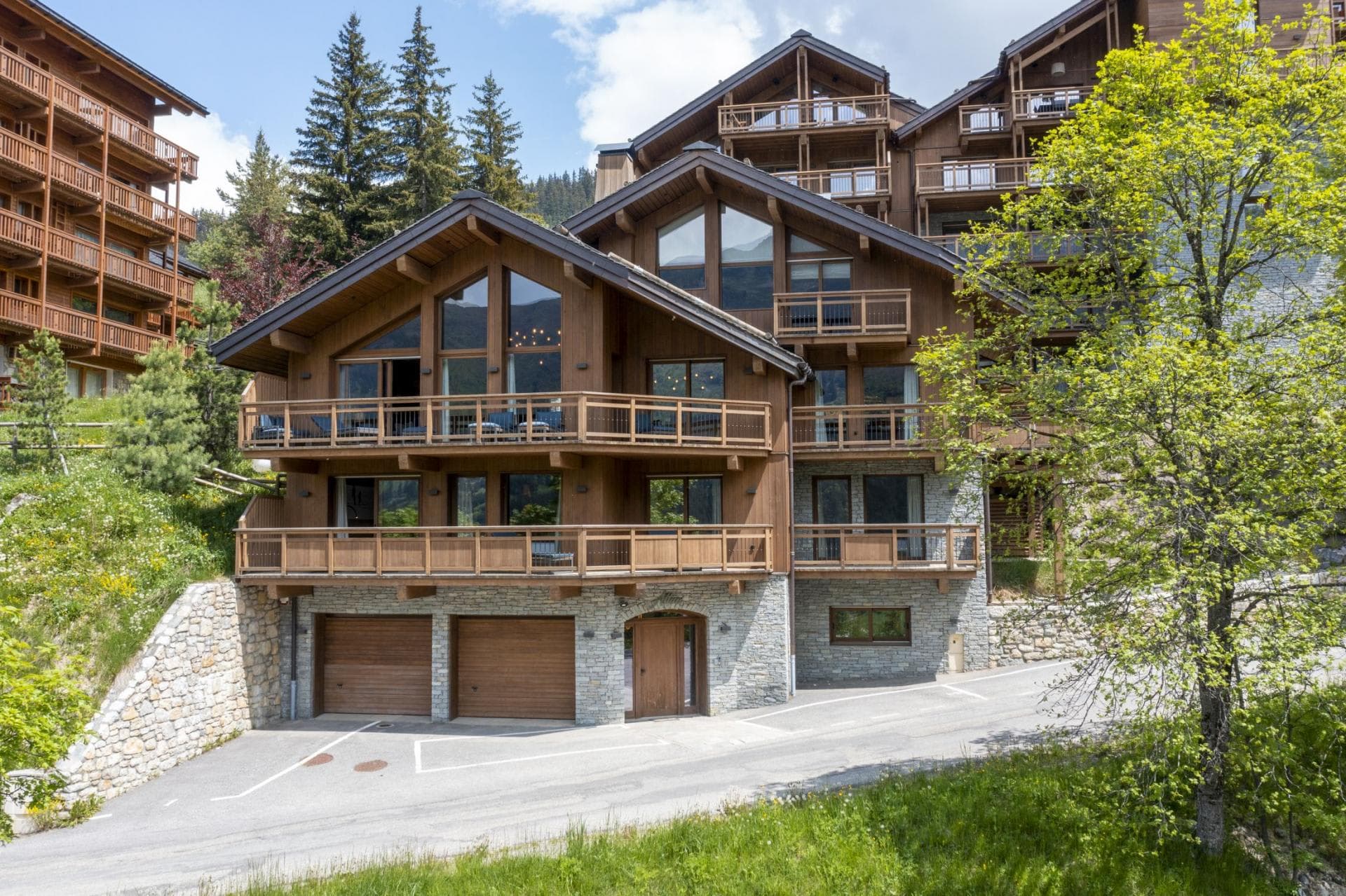 Chalet exterior with two-car garage and private balconies on every level