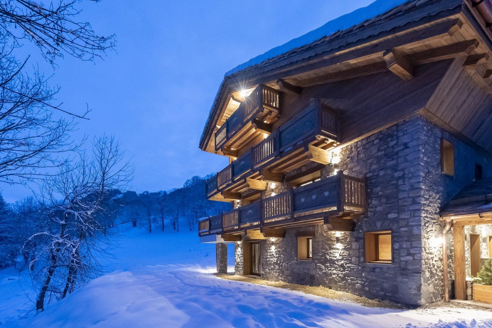 Ski-in/ski-out chalet exterior with private balconies and stone facade