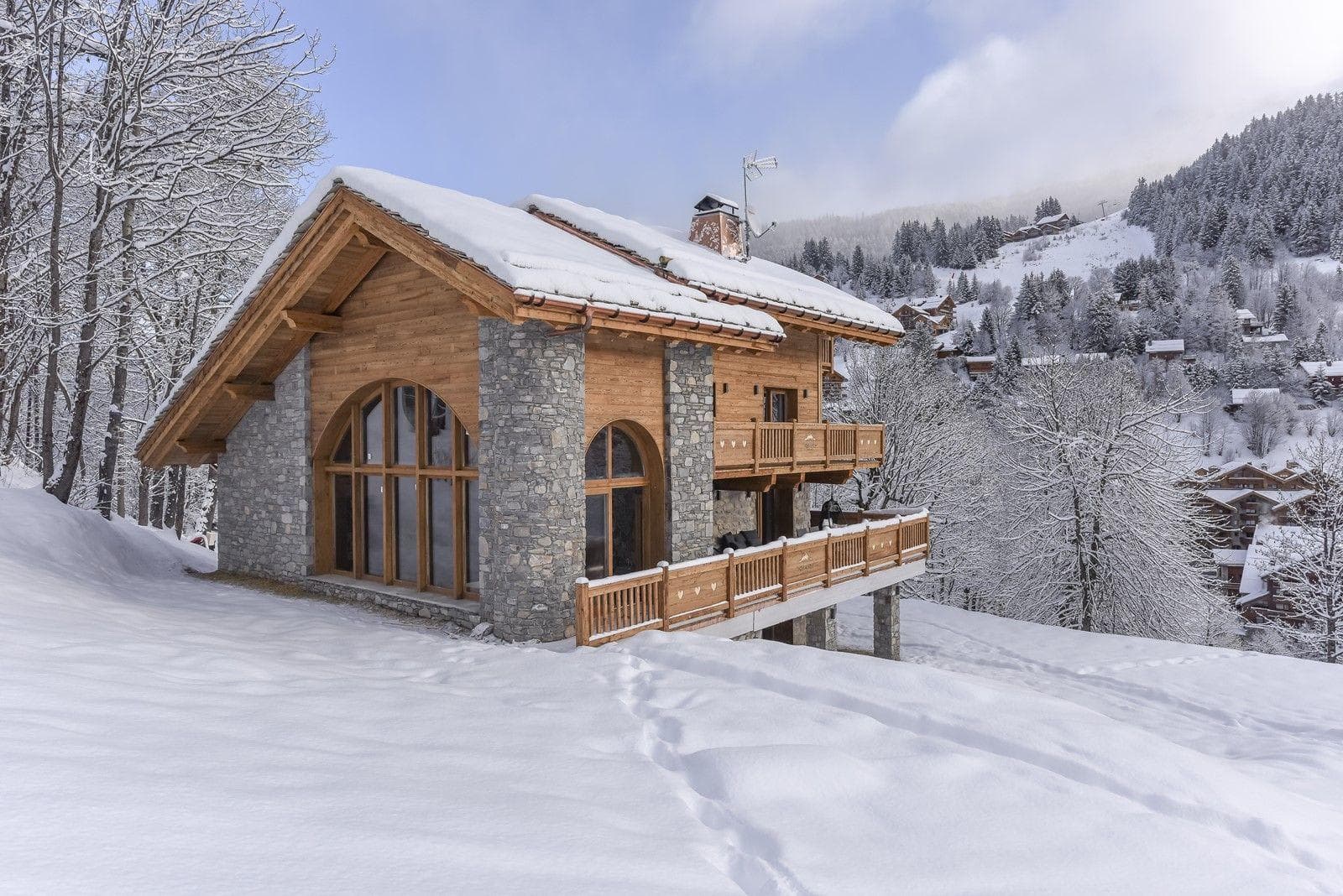 Ski-in/ski-out chalet exterior with wraparound balcony and mountain views