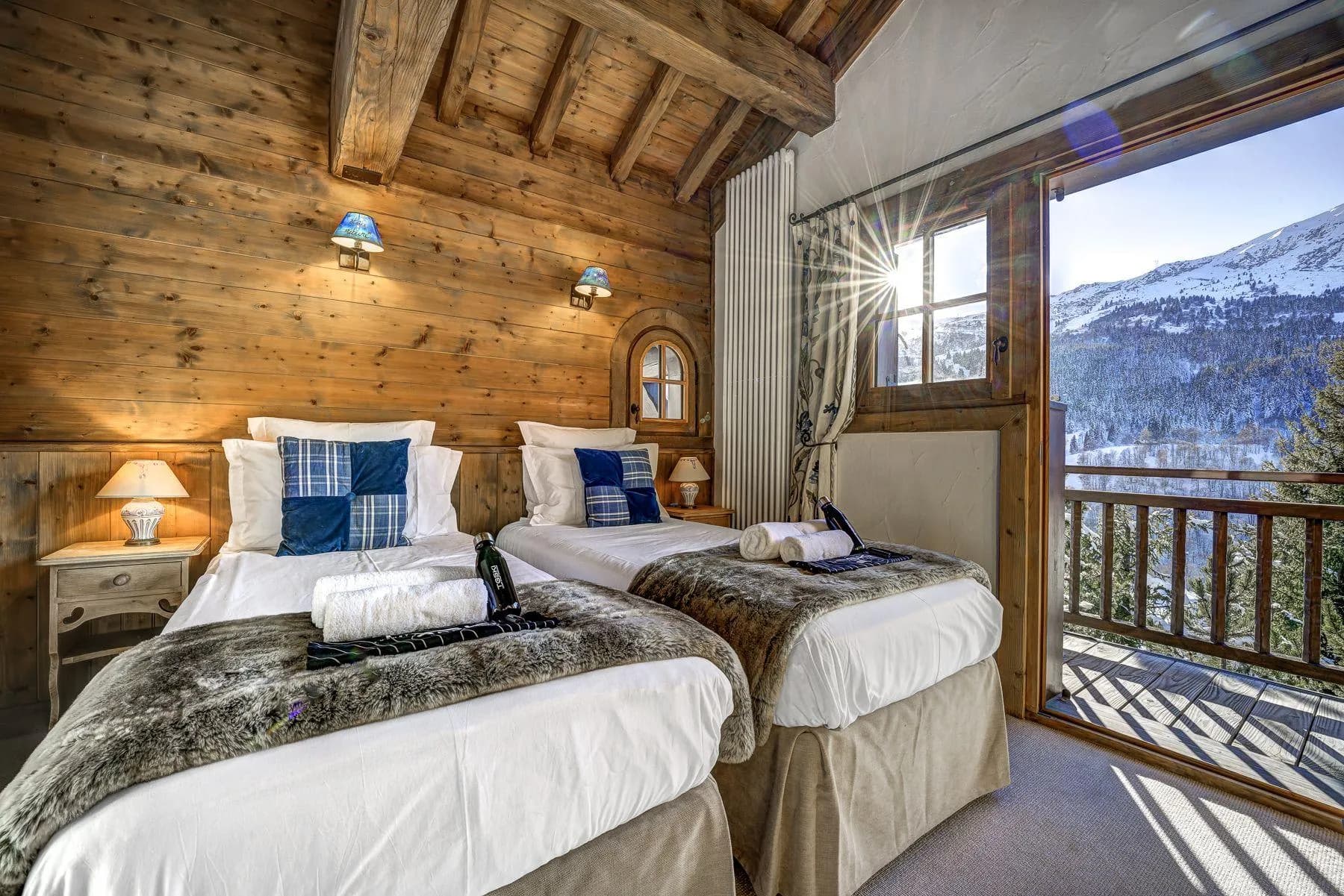 Guest bedroom with twin beds and private balcony access